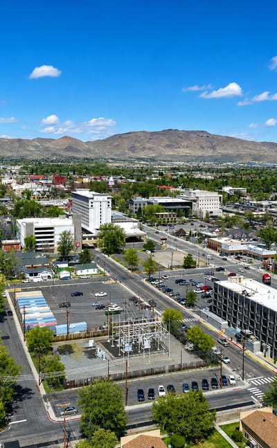 Aerial view of Carson City, Nevada's low downtown backed by high-desert mountains