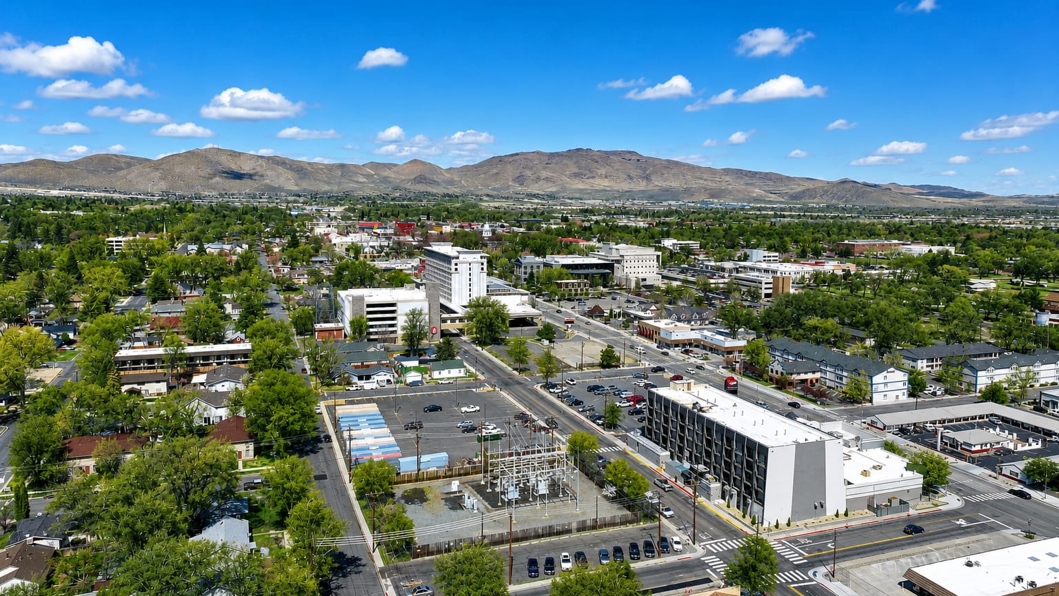 Aerial view of Carson City, Nevada's low downtown backed by high-desert mountains