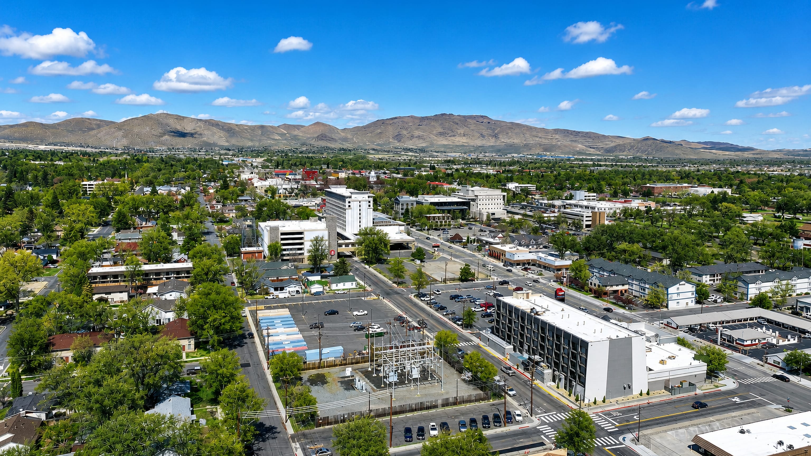 Aerial view of Carson City, Nevada's low downtown backed by high-desert mountains