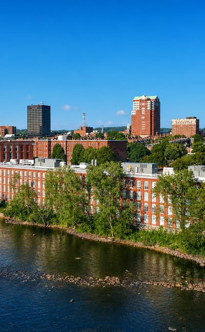Manchester, New Hampshire's red-brick Amoskeag mill buildings lining the Merrimack River below downtown.