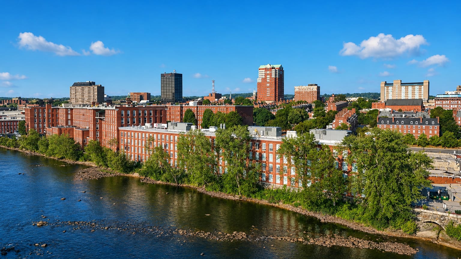 Manchester, New Hampshire's red-brick Amoskeag mill buildings lining the Merrimack River below downtown.