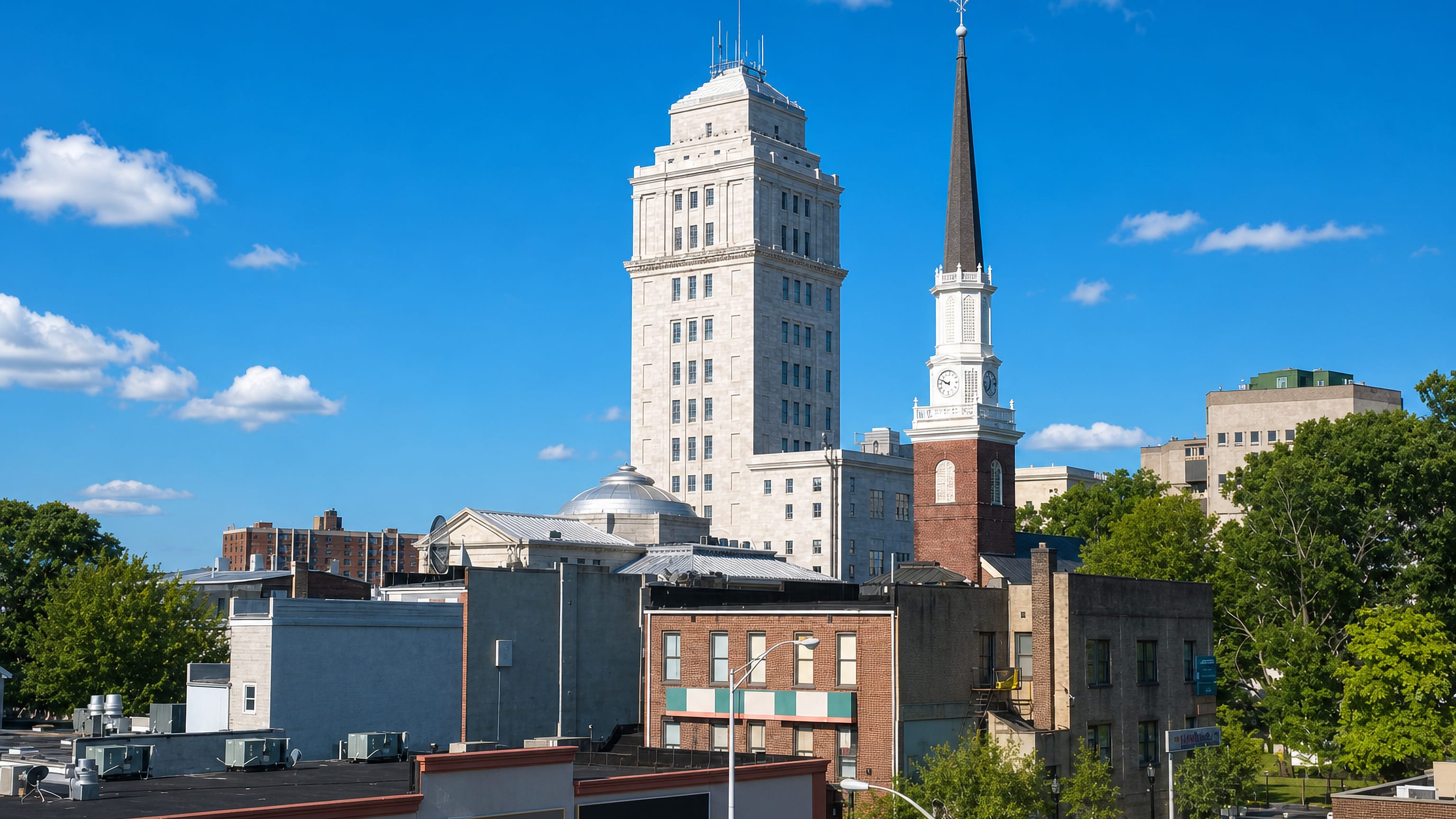 Downtown Elizabeth, New Jersey, with the Union County Courthouse tower and a tall white church steeple.
