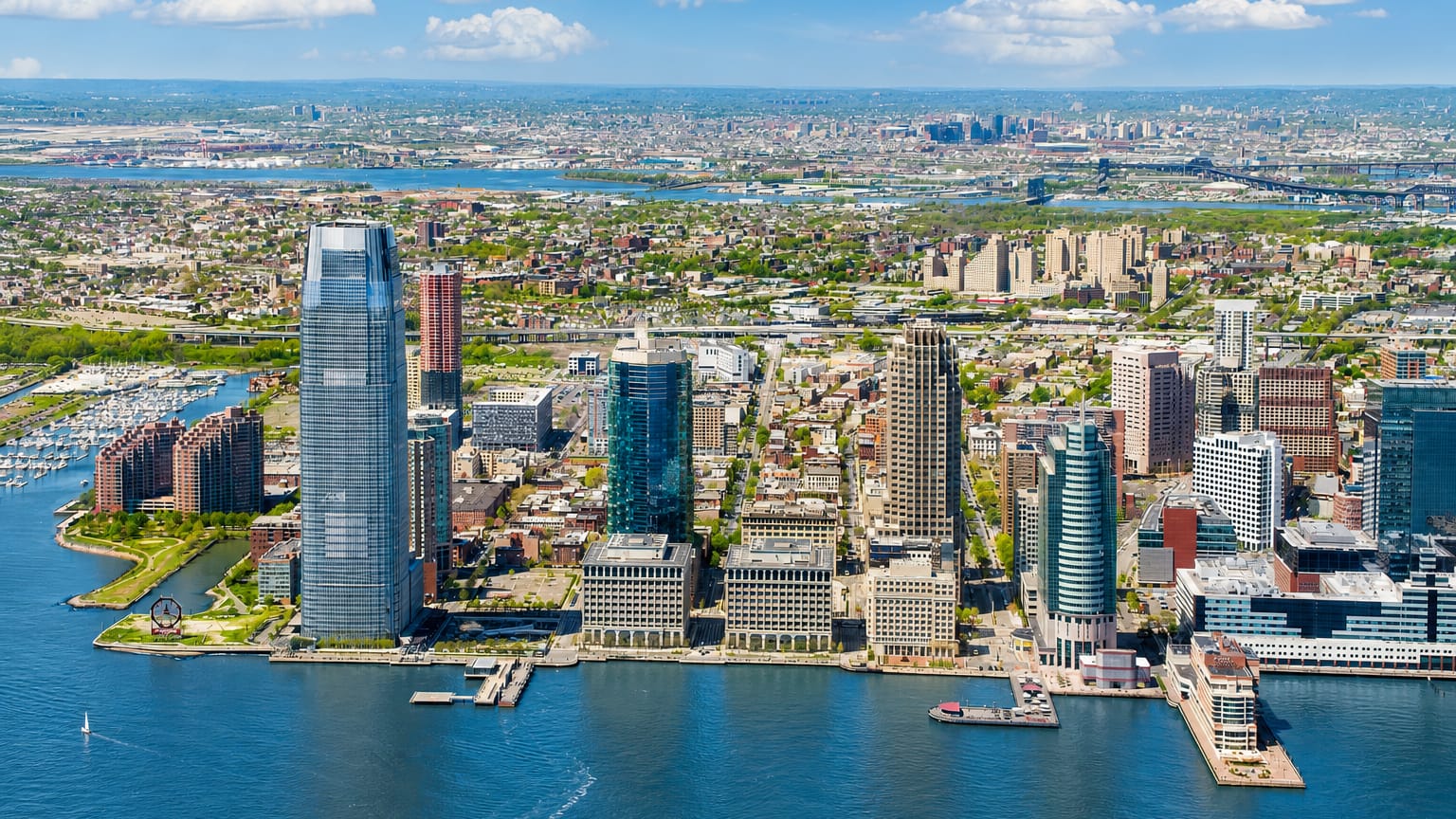 Jersey City, New Jersey waterfront skyline on the Hudson River, led by its tallest tower and a marina.