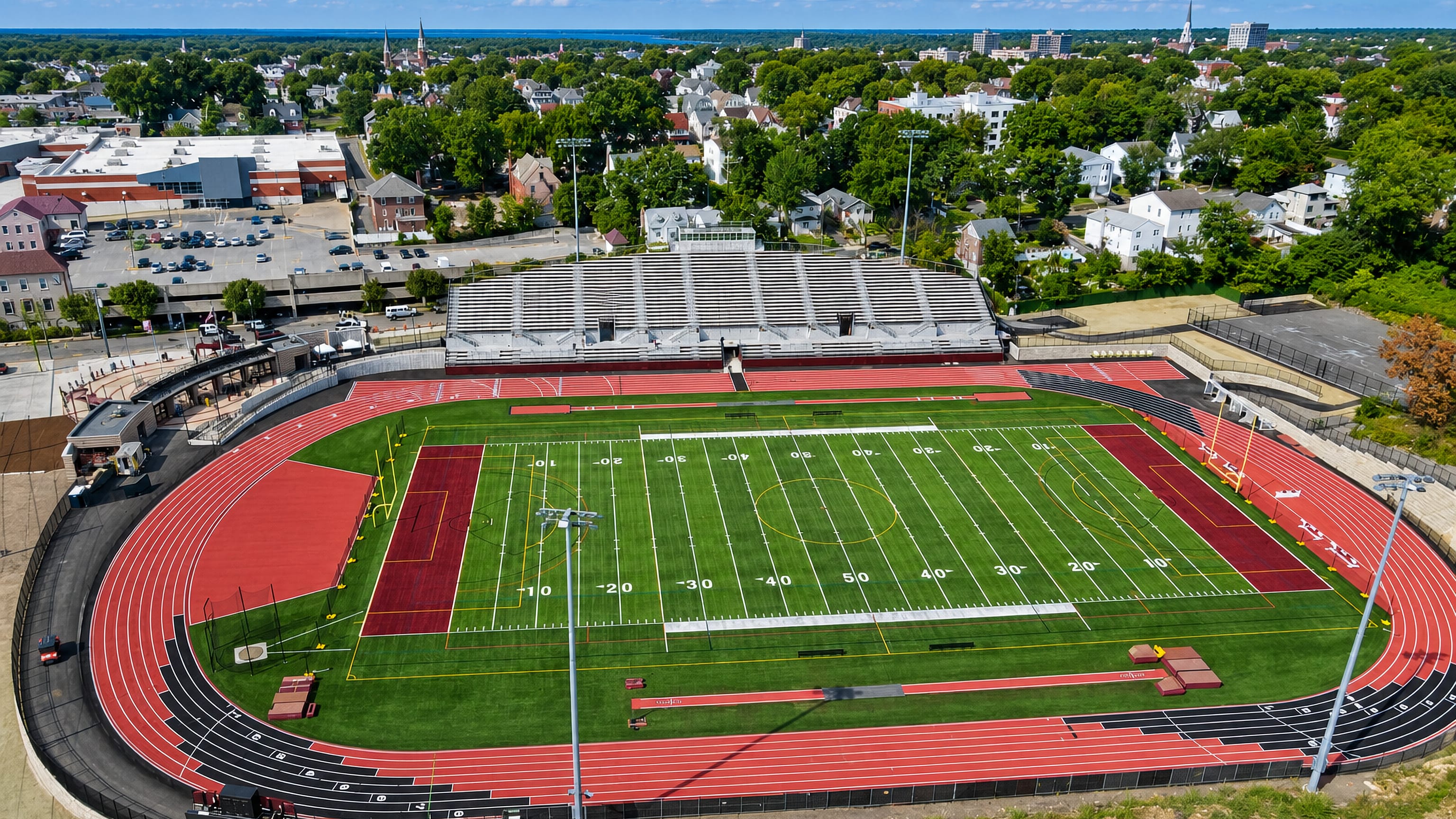 Aerial view of Mount Vernon, New York, over a stadium track and football field ringed by leafy neighbourhoods