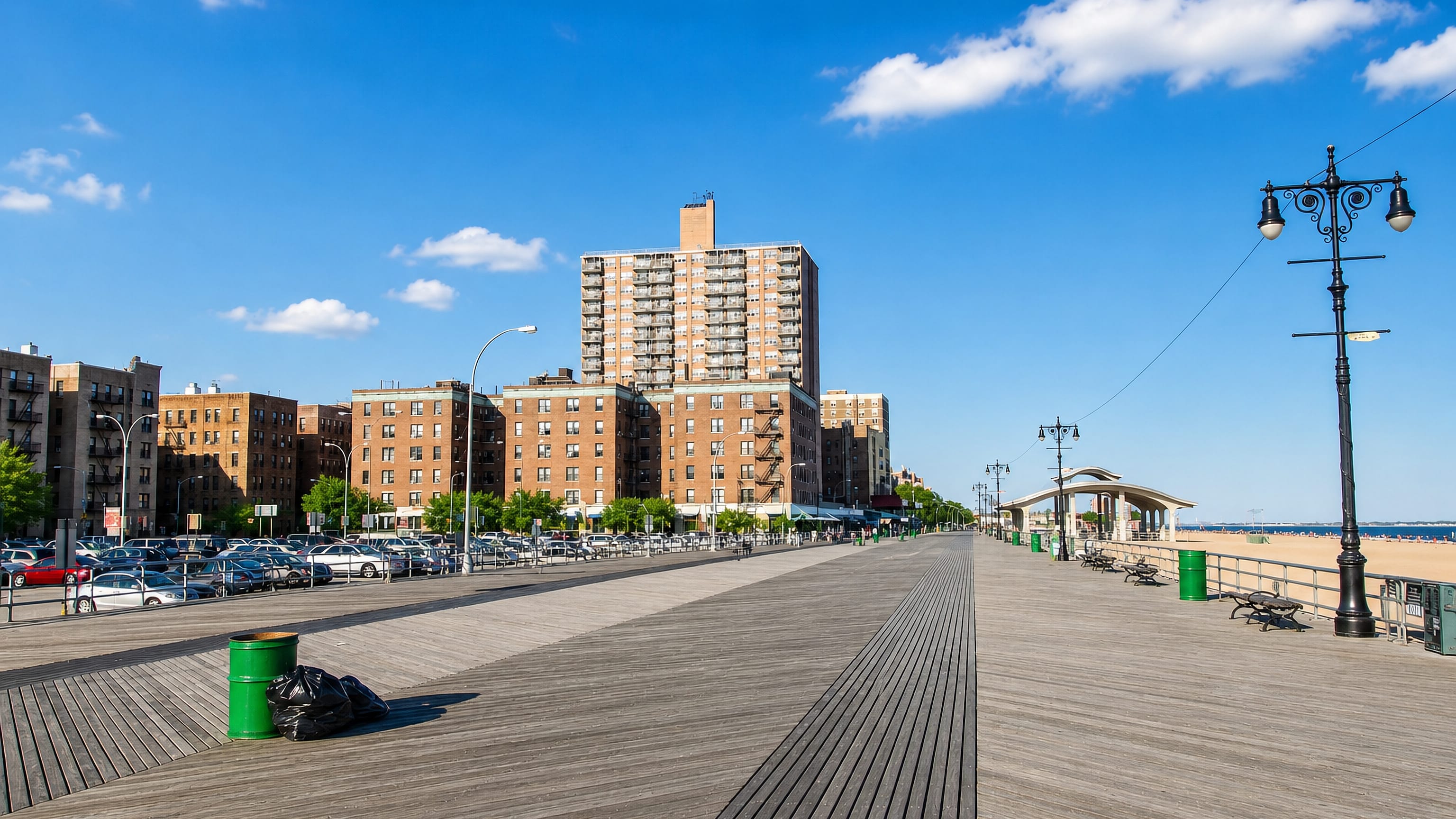 The wooden boardwalk and brick apartment blocks along the seafront at Brighton Beach, Brooklyn.