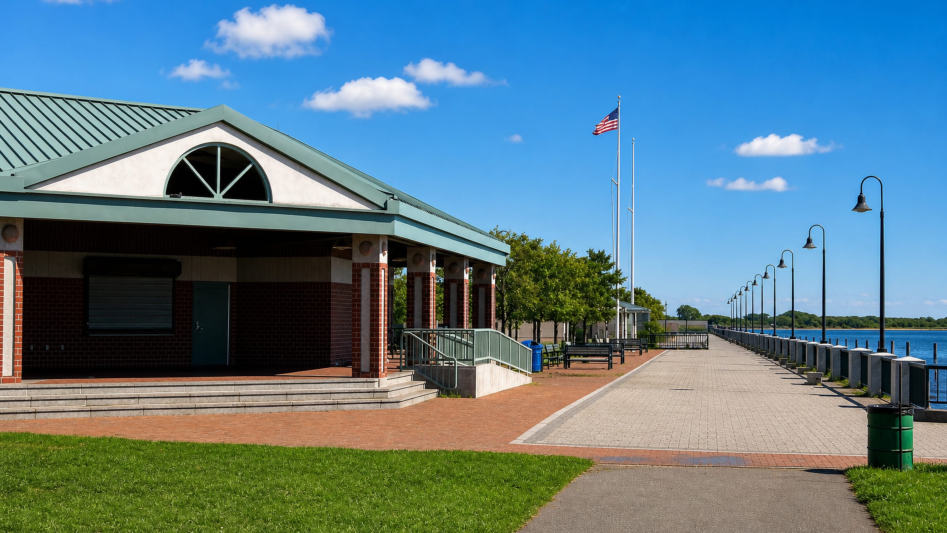 Brick waterfront pavilion and lamp-lined promenade beside the bay at Canarsie, Brooklyn, New York.