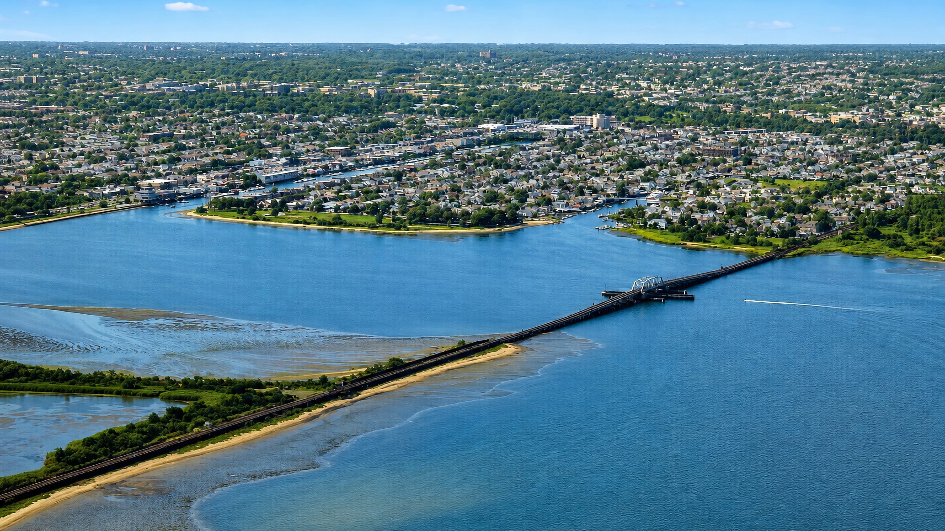 Aerial view of Howard Beach on Jamaica Bay, with the subway trestle crossing the marsh channels.