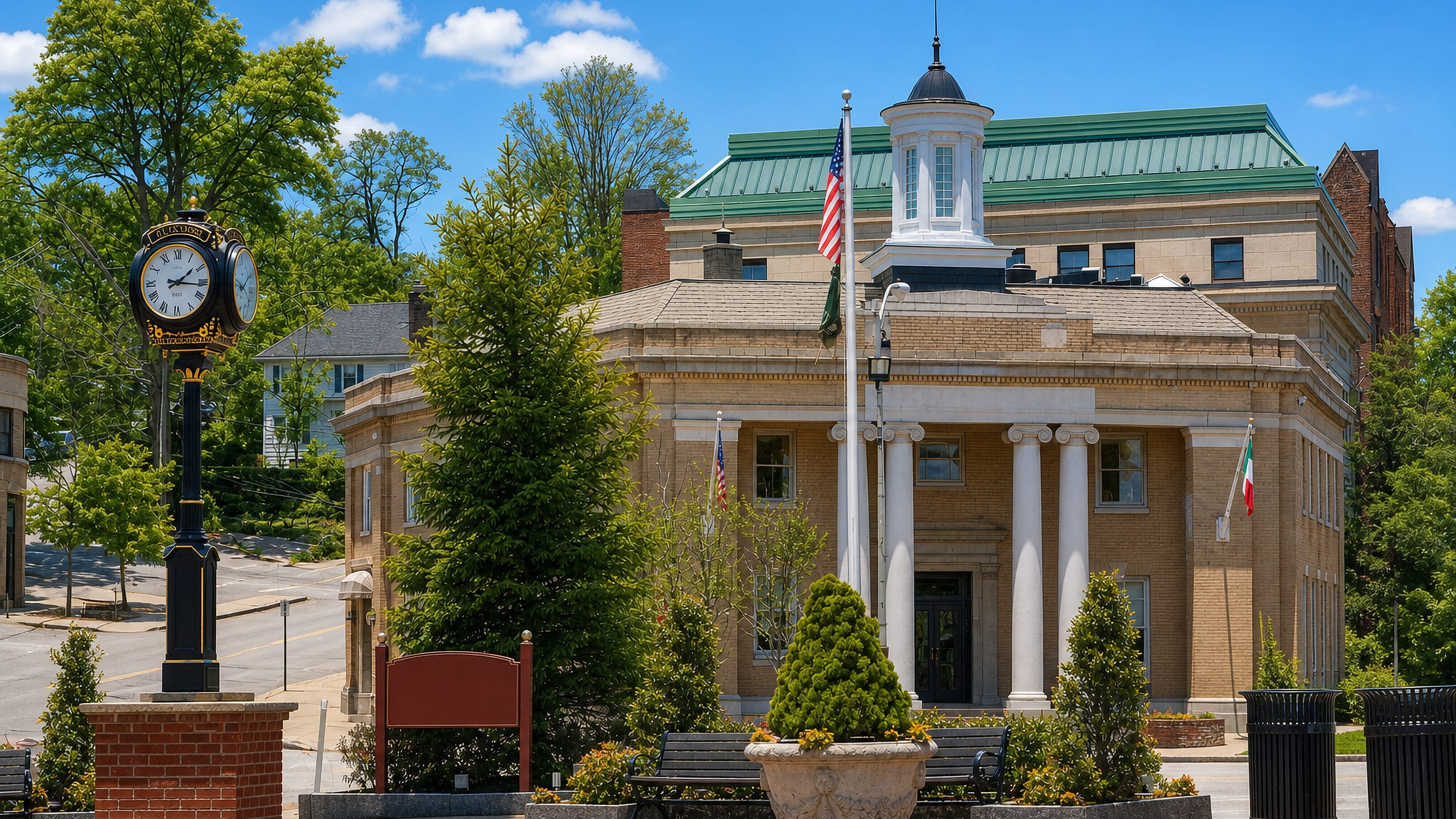 Columned bank building, street clock and flags in the village centre of Tuckahoe, New York.