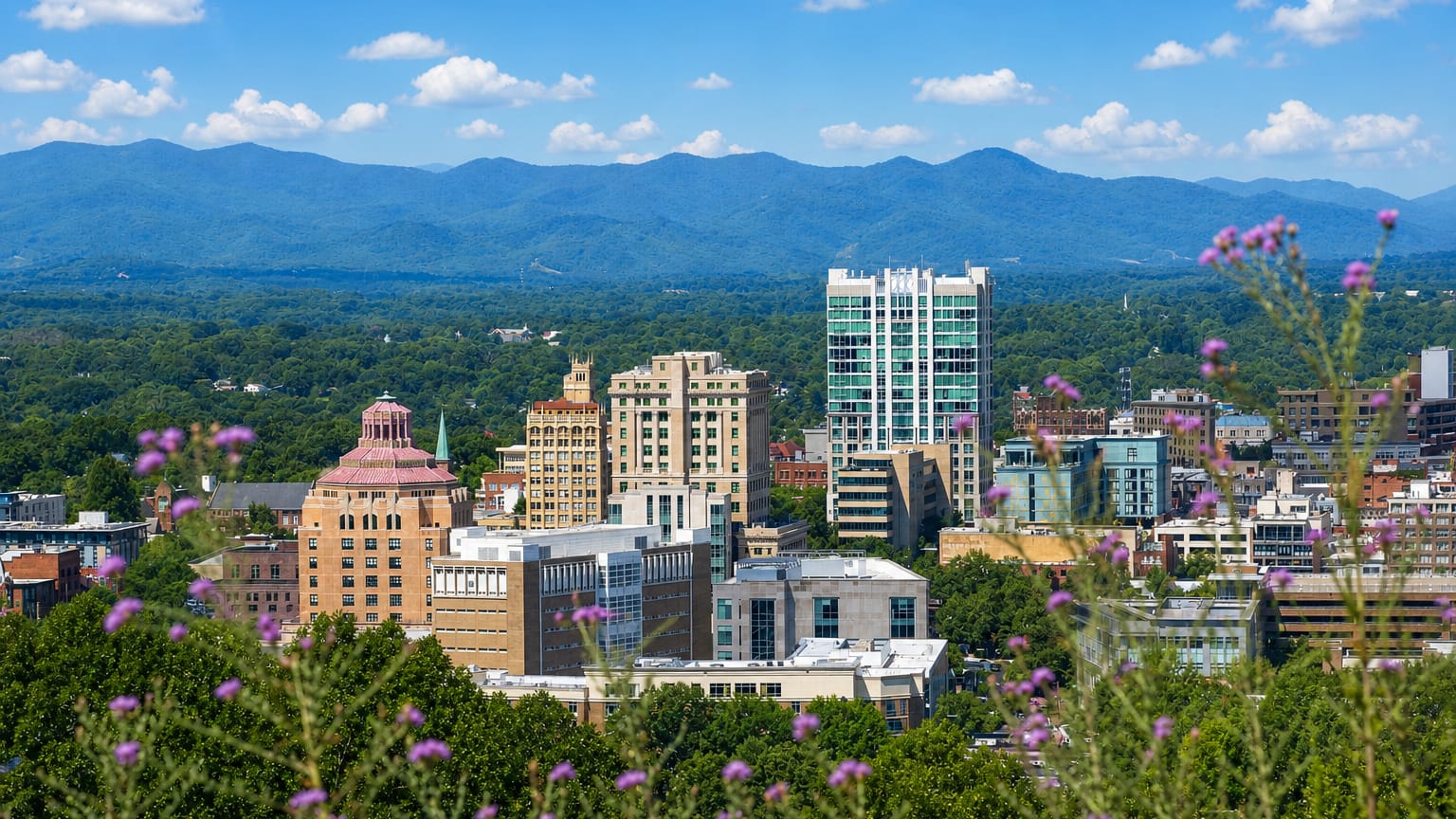 Downtown Asheville, North Carolina skyline with its Art Deco City Hall dome before the Blue Ridge Mountains.