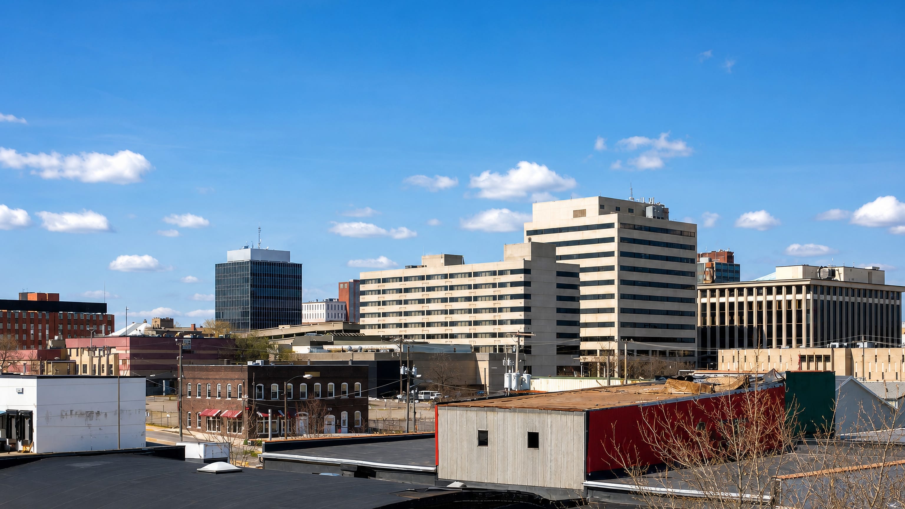 Mid-rise downtown office towers of Canton, Ohio, seen across low rooftops on a clear winter day.