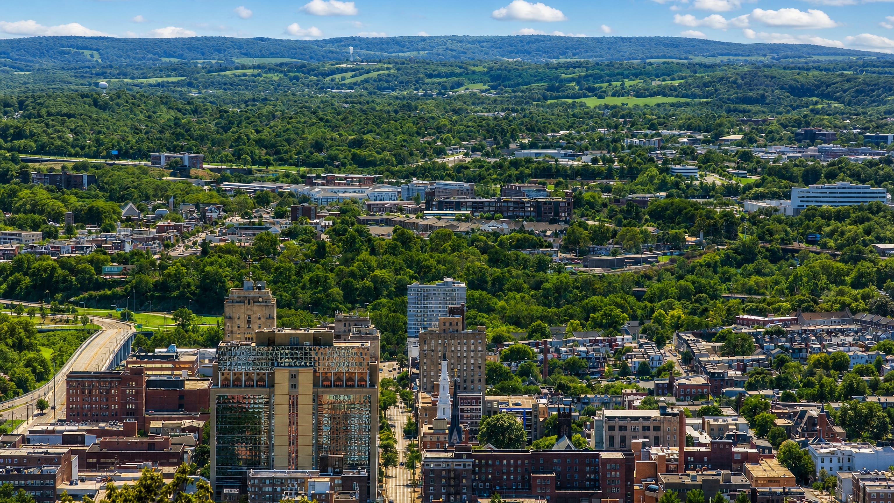 Downtown Reading, Pennsylvania seen from Mount Penn, with row houses and the wooded Berks County ridges.