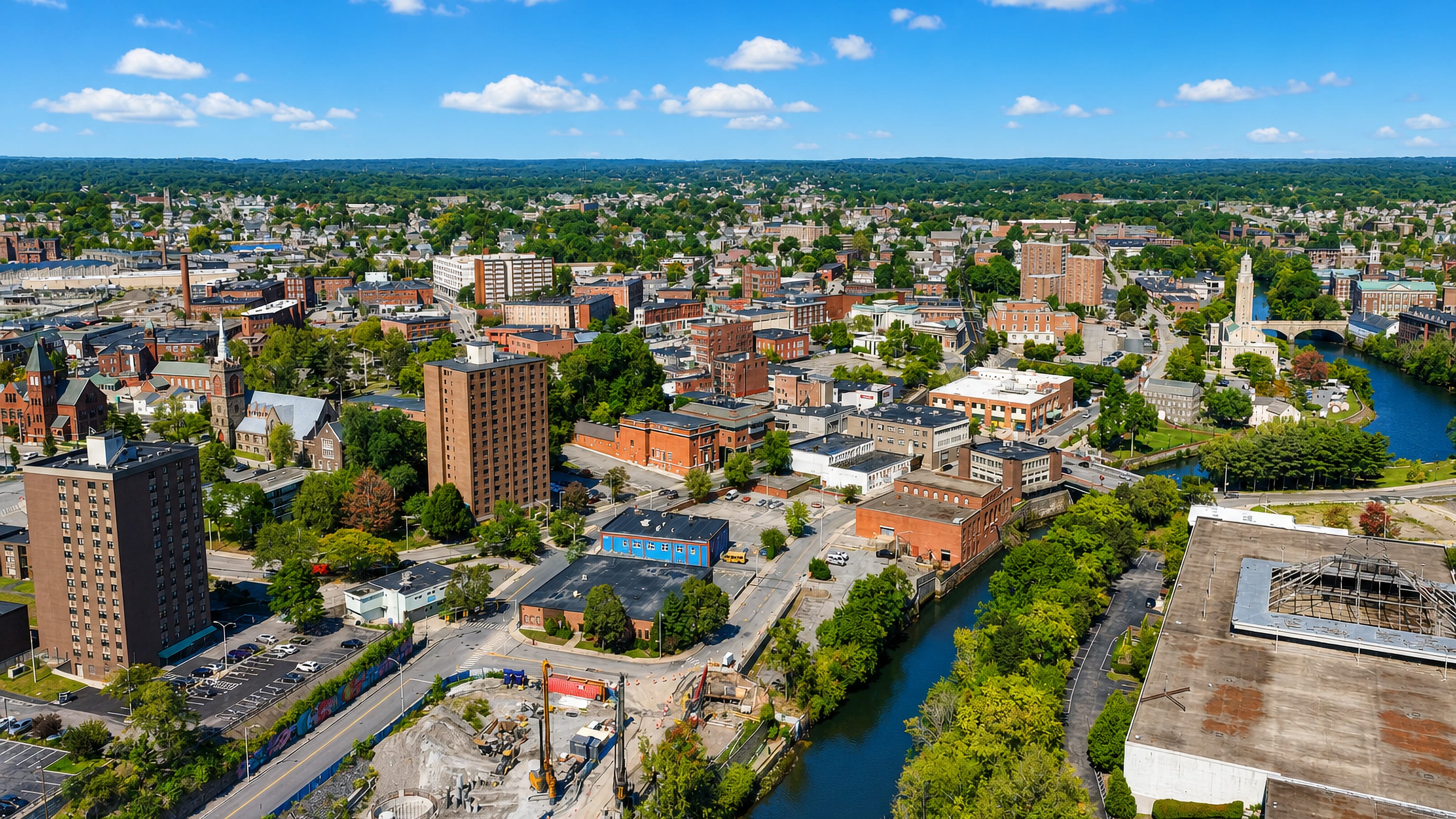 Red-brick mills, church spires and a civic clock tower along the Blackstone River in Pawtucket, Rhode Island.