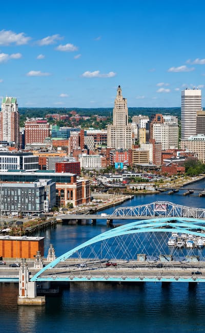 Skyline of Providence, Rhode Island, with its teal river bridge, art-deco tower and power-plant smokestacks