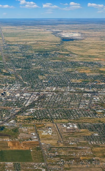 High aerial view of Amarillo, Texas spread across the flat Panhandle plains under a wide sky