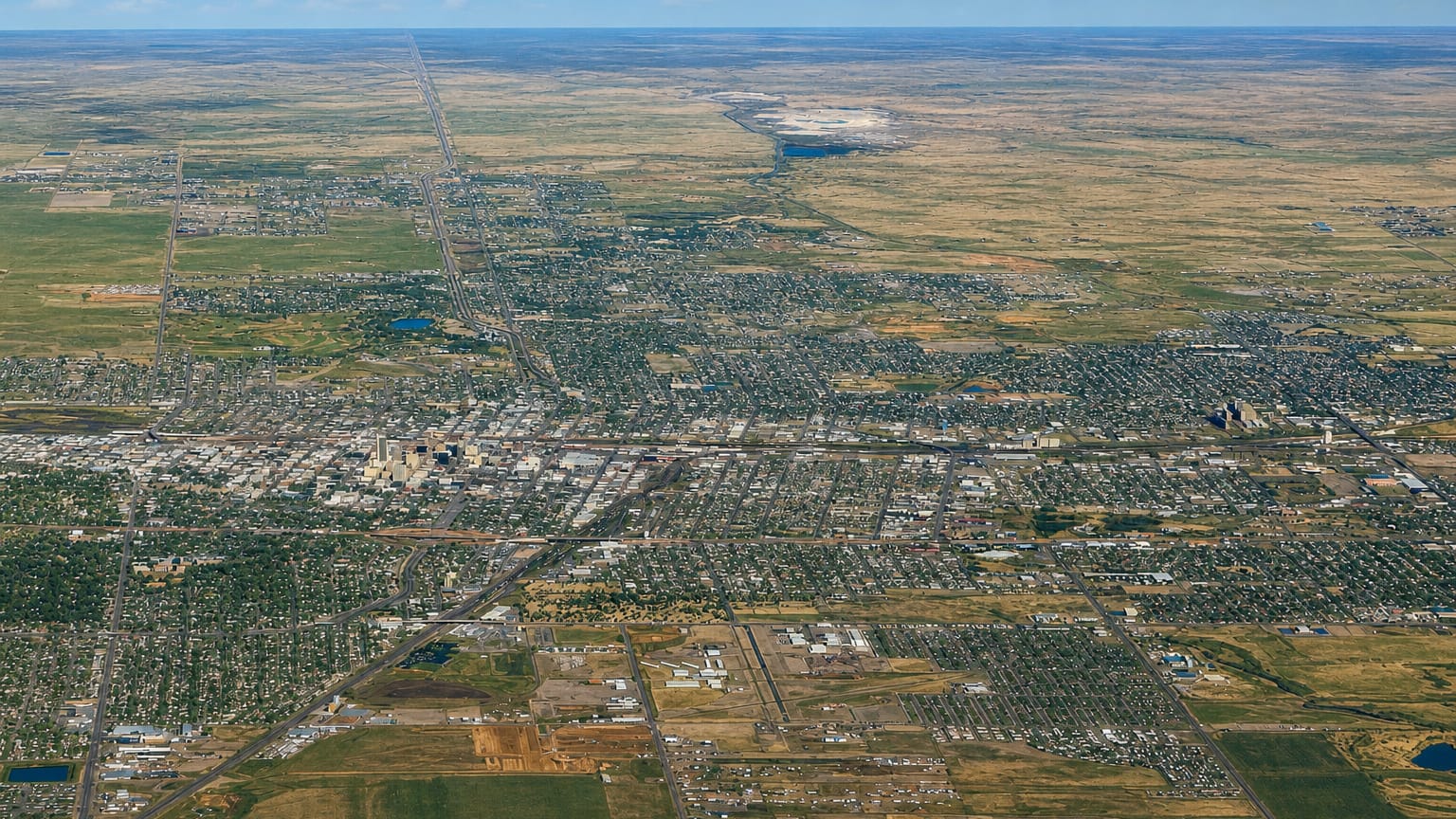 High aerial view of Amarillo, Texas spread across the flat Panhandle plains under a wide sky