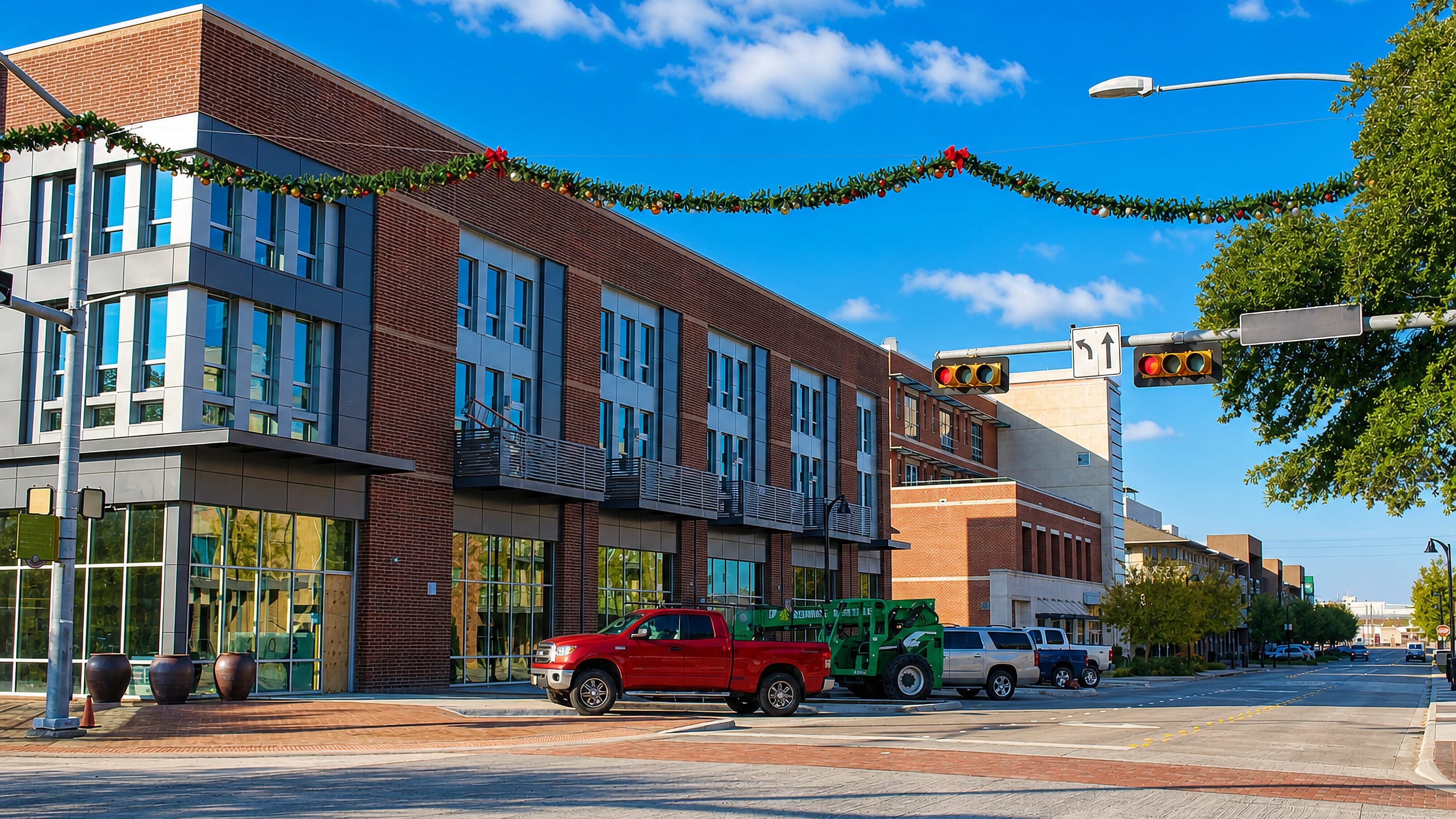 Brick mixed-use buildings and a traffic signal along a downtown street in Garland, Texas.