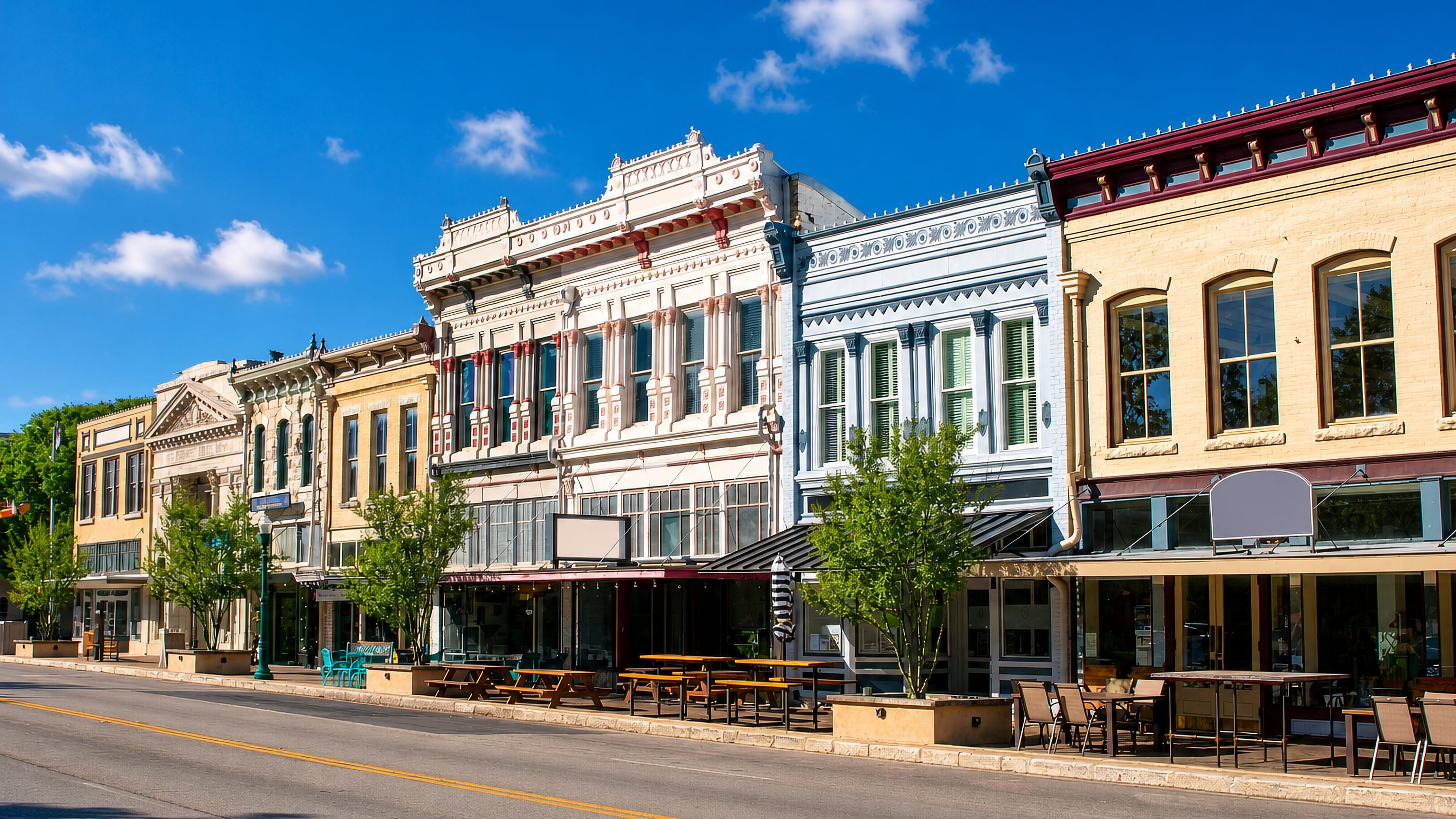Victorian limestone storefronts and pavement tables on the historic square in Georgetown, Texas.