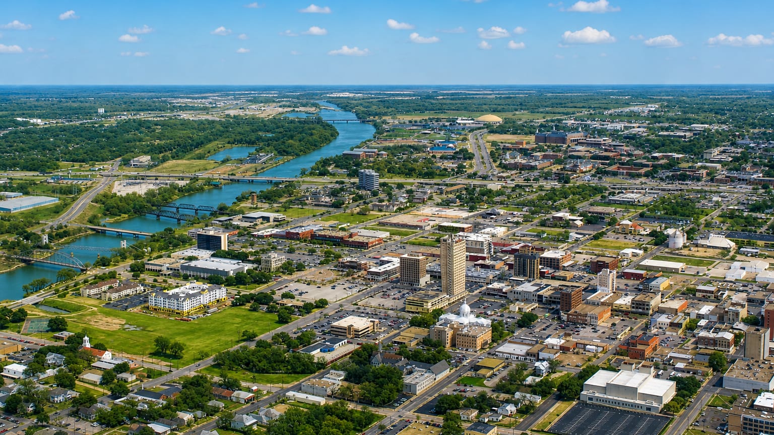 Aerial view of Waco, Texas, with the ALICO tower, county courthouse dome and the Brazos River through downtown.
