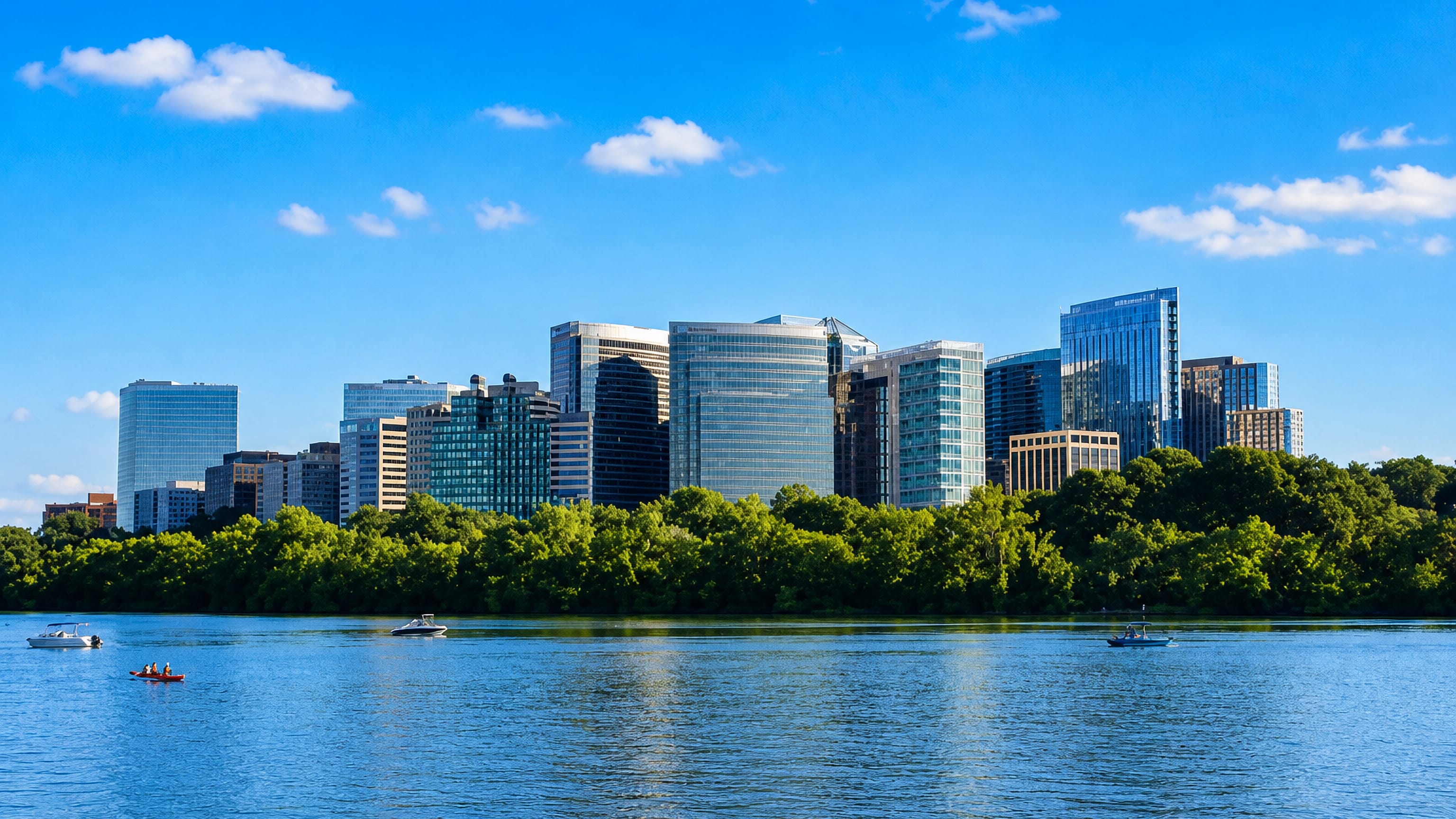 Arlington's Rosslyn high-rise skyline rising above tree-lined banks of the Potomac River on a clear day