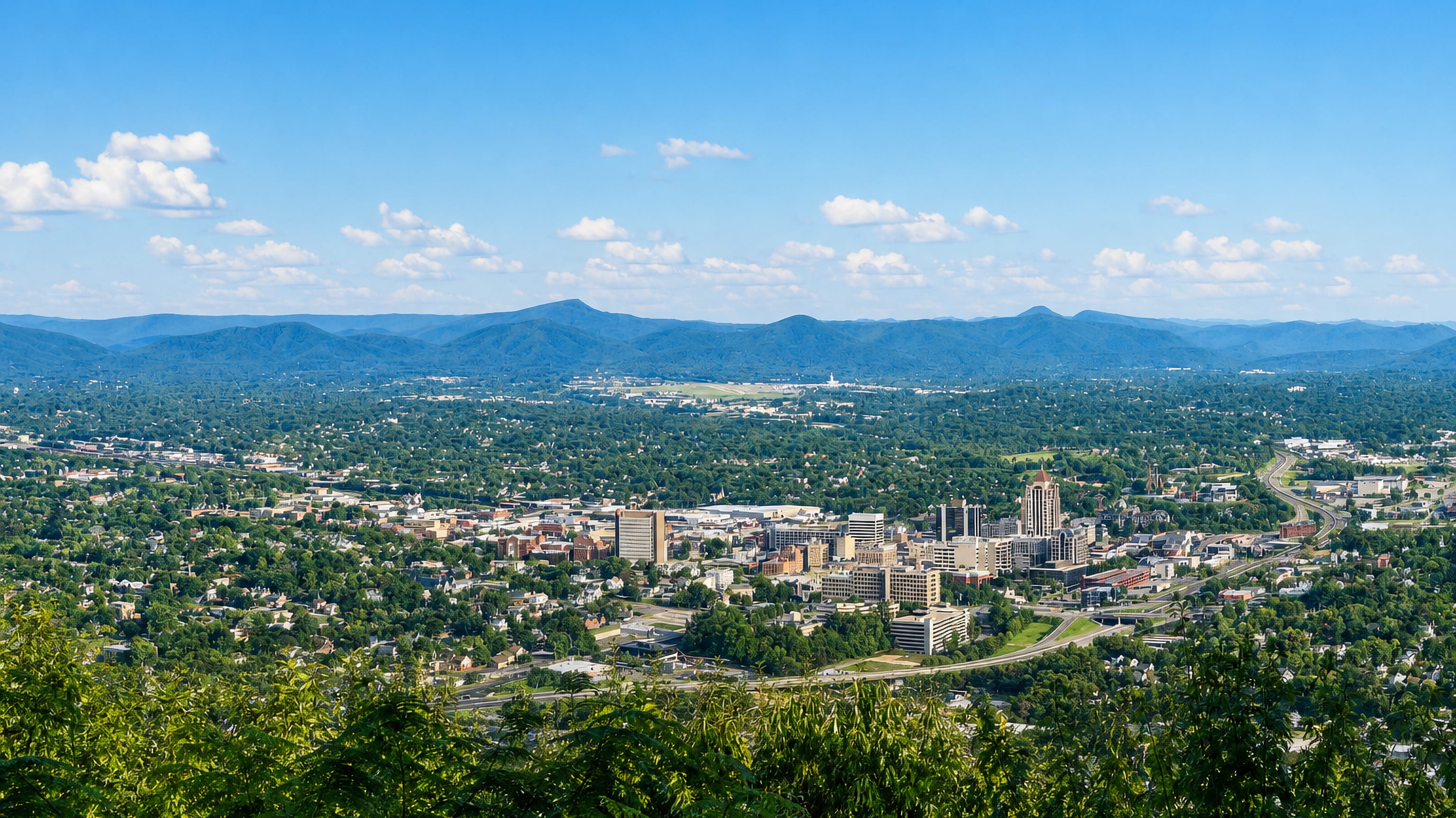 Downtown Roanoke, Virginia in its wooded valley below the Blue Ridge Mountains, seen from Mill Mountain.
