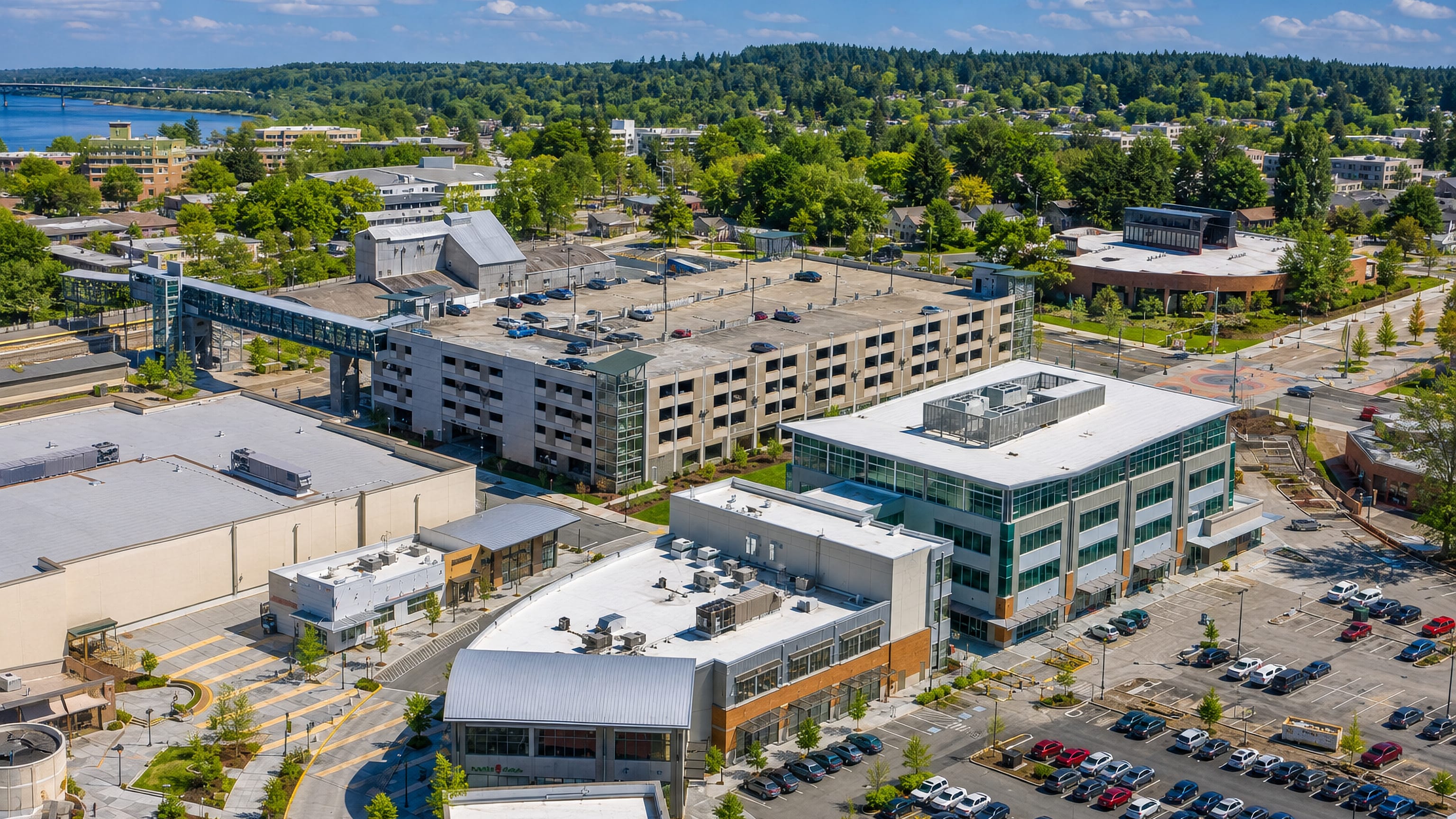 Aerial view of Kent, Washington, with its transit-centre parking garage, pedestrian bridge and retail blocks.
