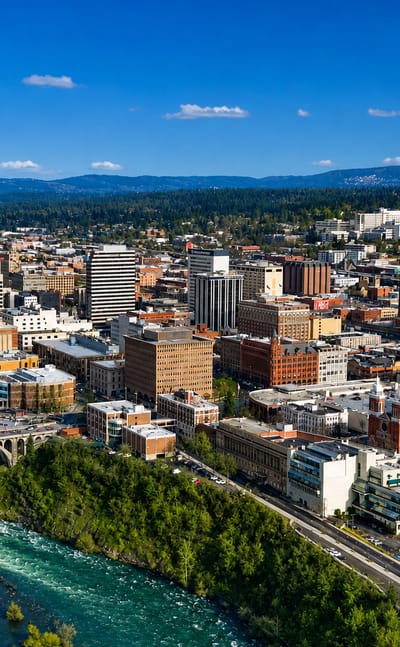 Aerial view of downtown Spokane, Washington with the Spokane River and the arched Monroe Street Bridge.