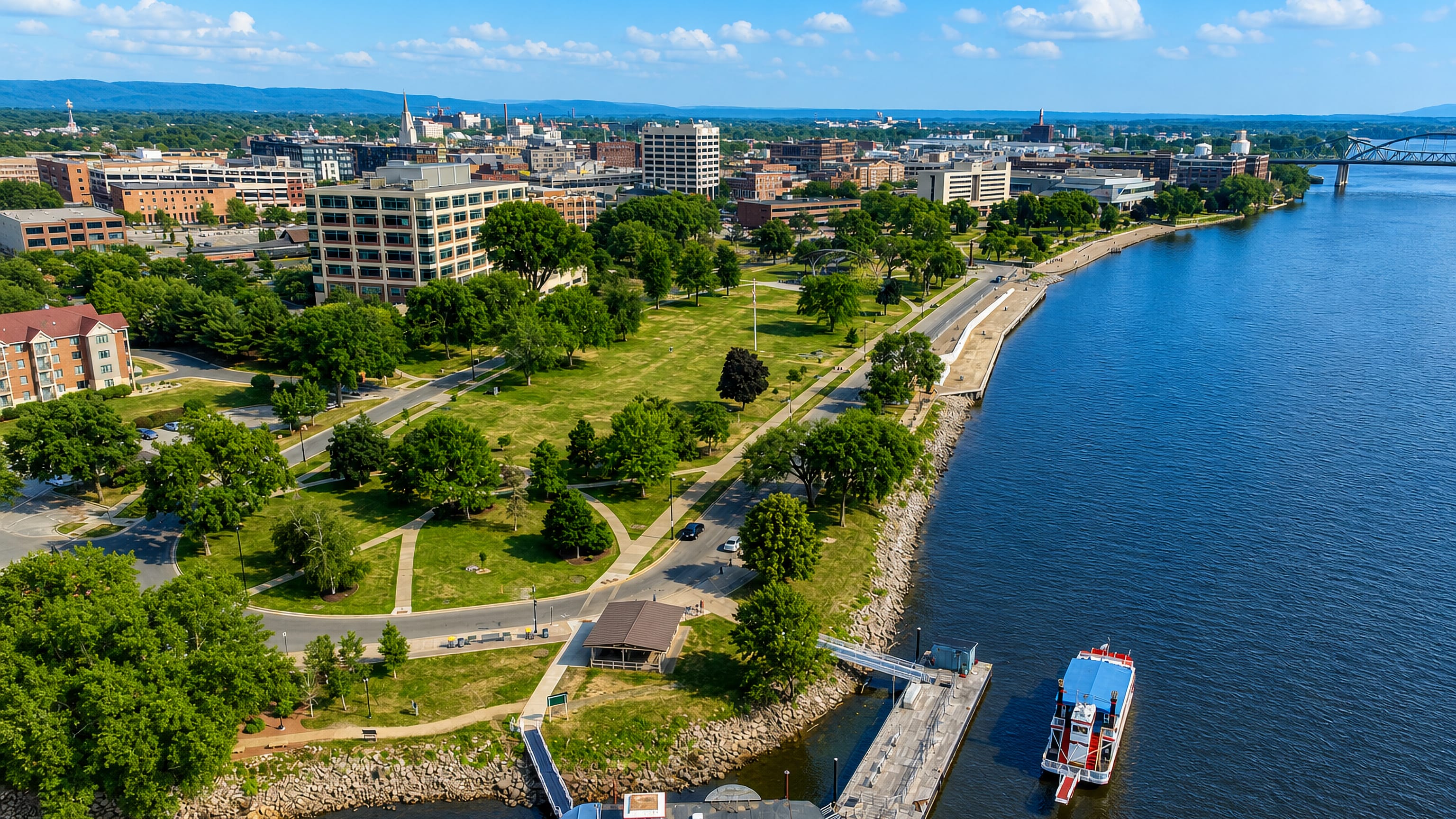 Riverside Park and downtown La Crosse, Wisconsin, on the Mississippi with a paddlewheel riverboat at the levee.
