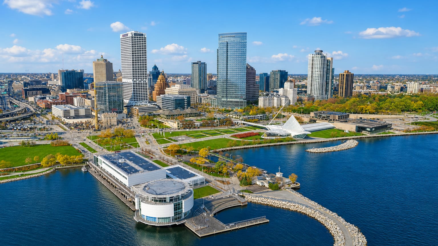Aerial view of the Milwaukee lakefront with the white Milwaukee Art Museum pavilion and downtown skyline.