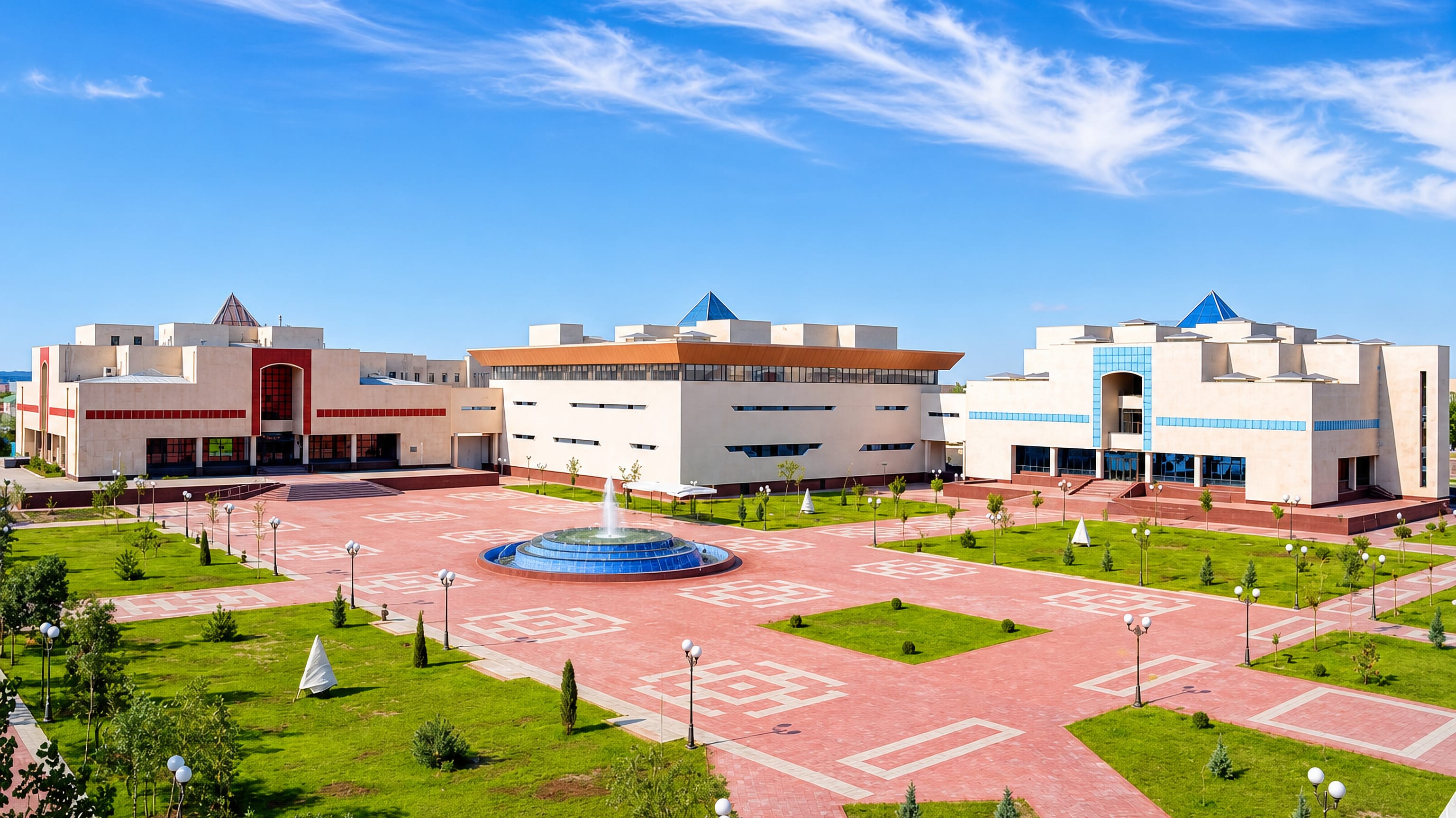 Nukus civic square in Karakalpakstan with a fountain, patterned brick paving and white monumental museum buildings.