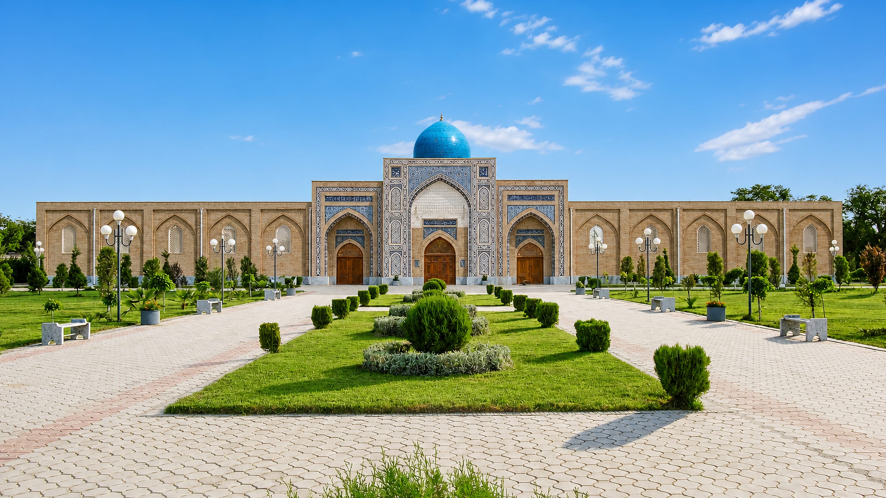 Turquoise-domed madrasa with a tiled portal and formal gardens in Qarshi, Uzbekistan.