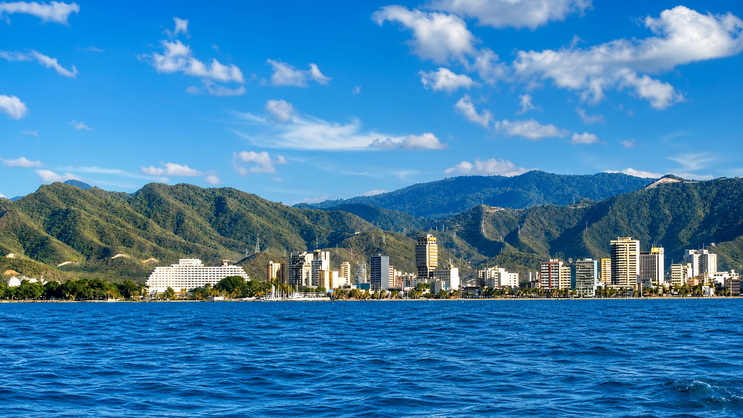 Puerto La Cruz, Venezuela, seen from the Caribbean, its waterfront towers backed by green coastal mountains
