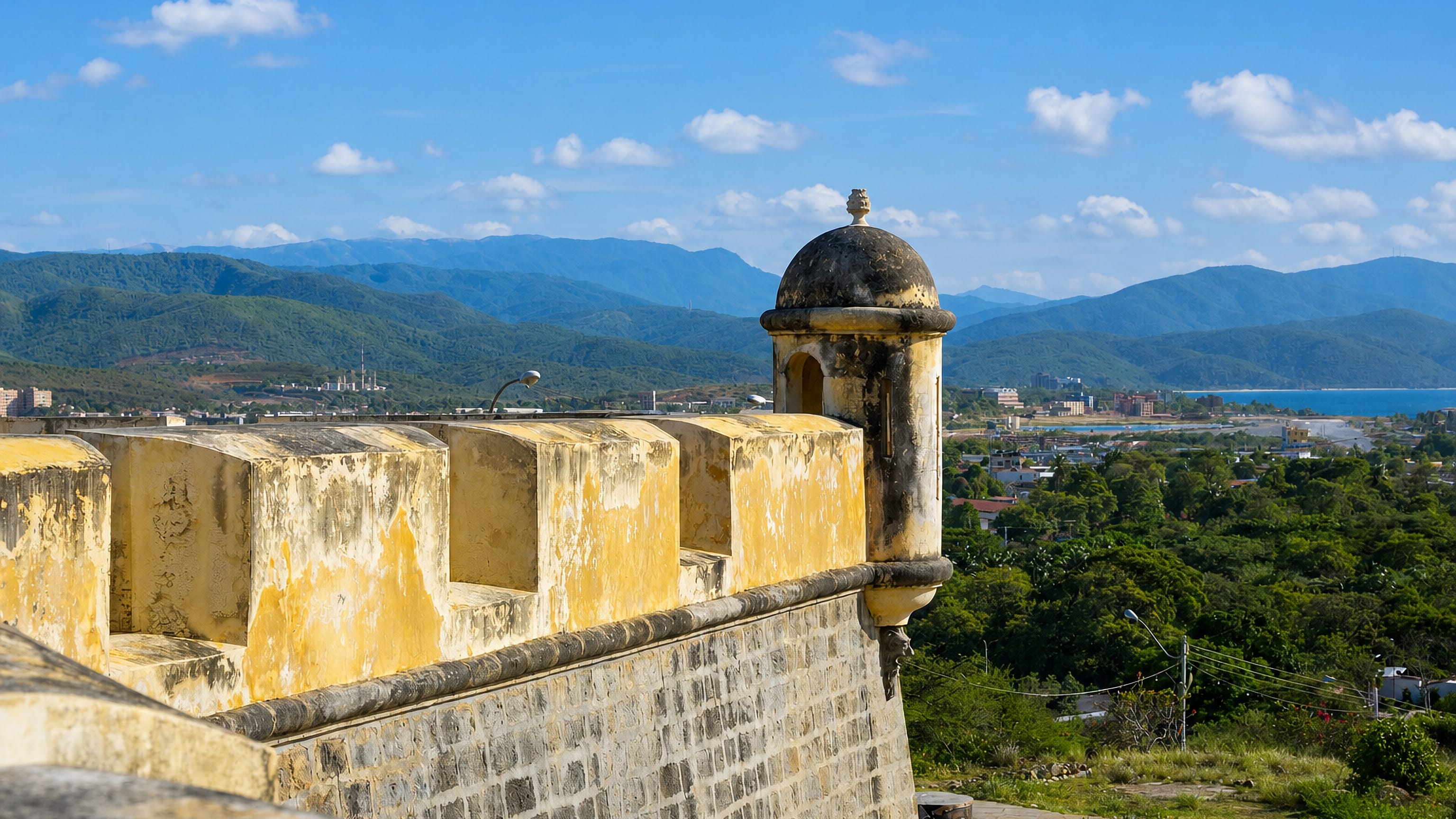 Ramparts of the hilltop Castillo San Antonio overlooking Cumaná, Venezuela, the coast and green mountains.