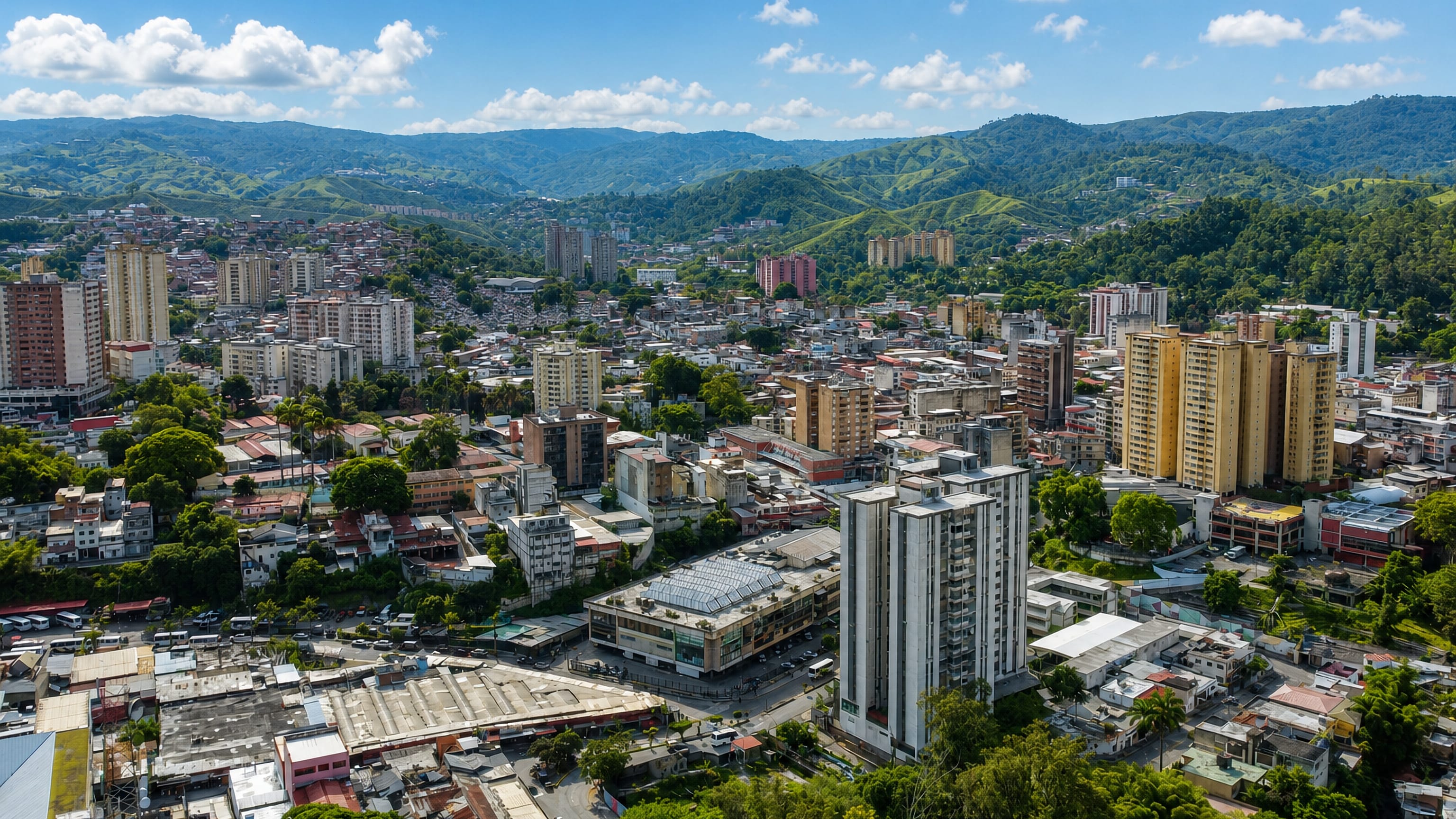 Aerial view of Los Teques, Venezuela, its apartment towers packed into a valley ringed by green mountains.