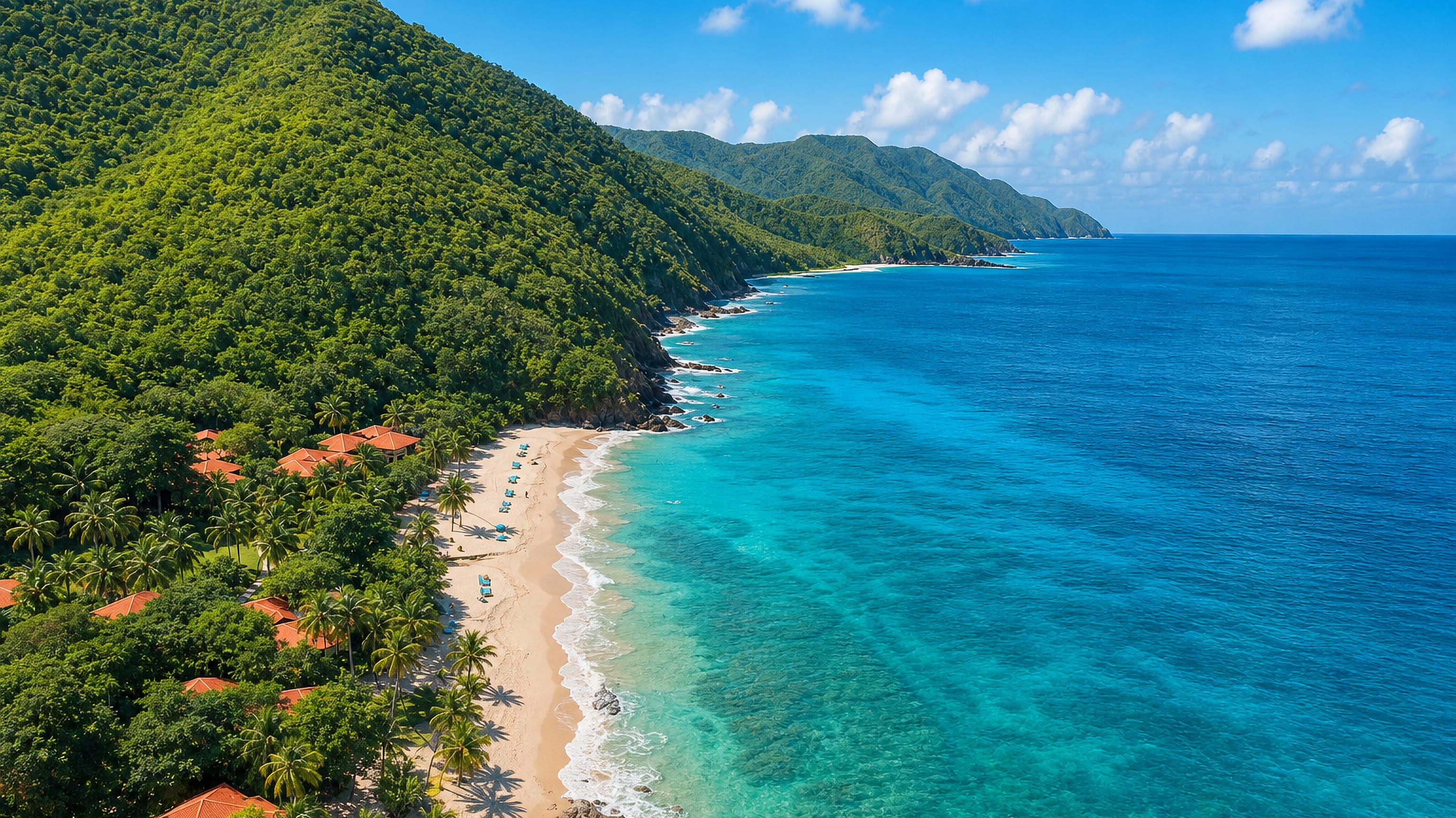 Saint Croix's forested north shore, with a sandy beach, red-roofed villas and turquoise Caribbean water.