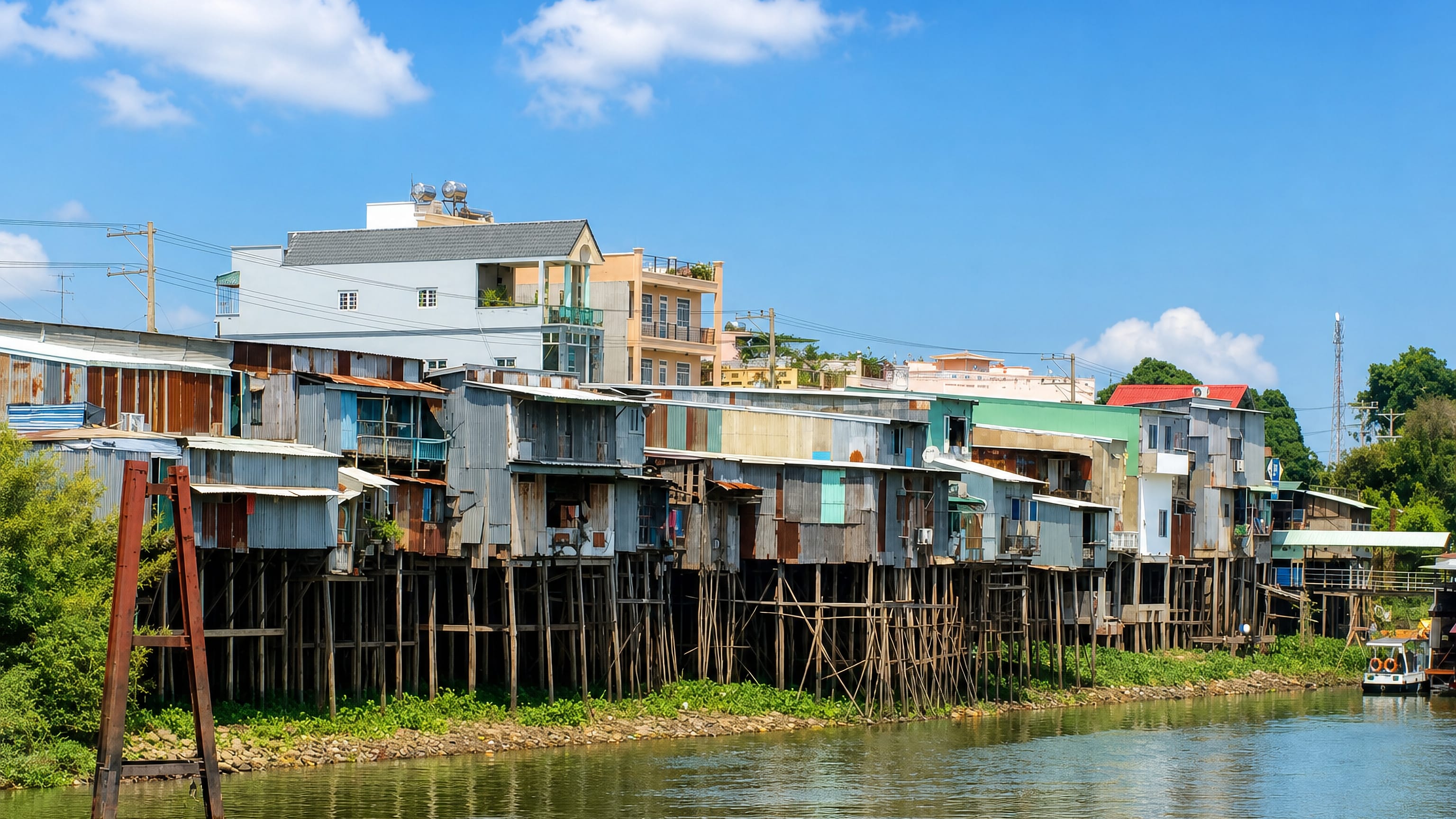 Corrugated-iron stilt houses lining the riverbank at Châu Đốc in Vietnam's Mekong Delta