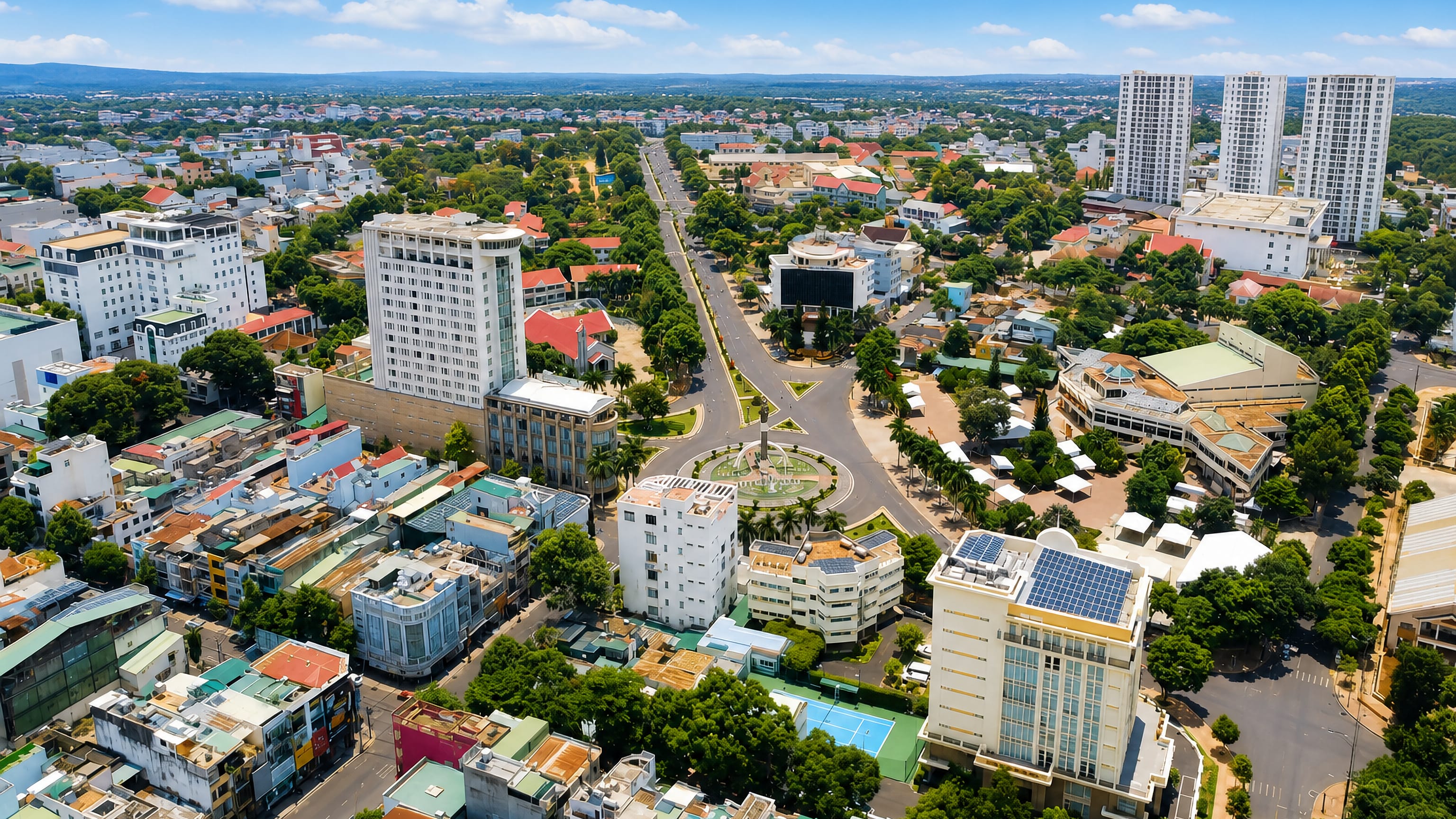 Aerial view of Buon Ma Thuot, Vietnam, with avenues radiating from the central monument roundabout.