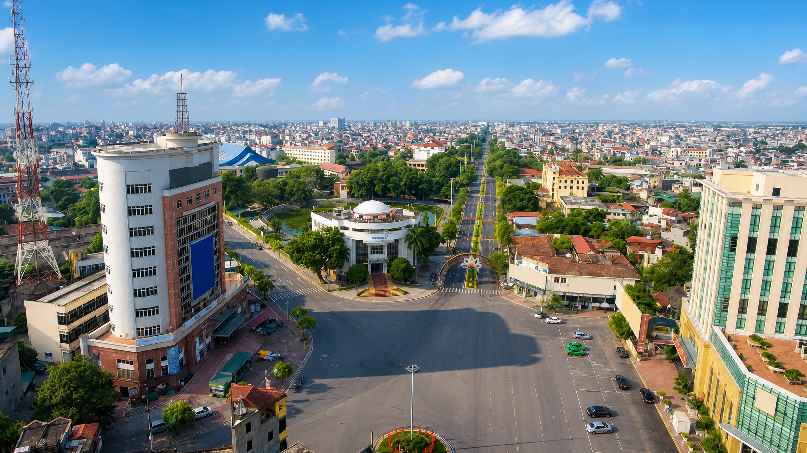 Aerial view of Hải Dương, Vietnam, along a broad tree-lined boulevard with a domed rotunda building.