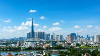 Ho Chi Minh City skyline with the towering Landmark 81 spire and the Bitexco tower rising over the Saigon River