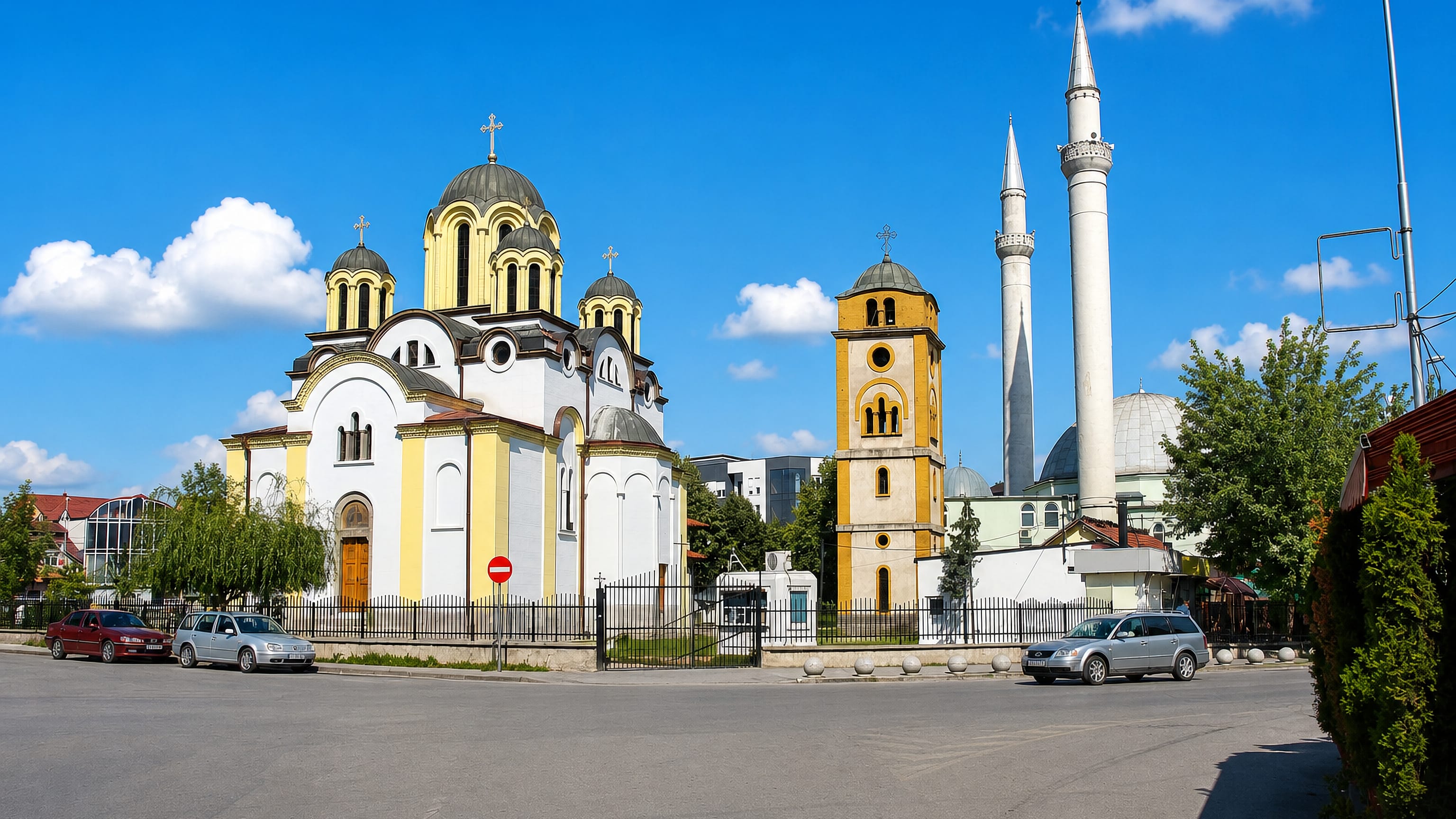 Orthodox church and the mosque's minarets standing side by side in the centre of Ferizaj, Kosovo.