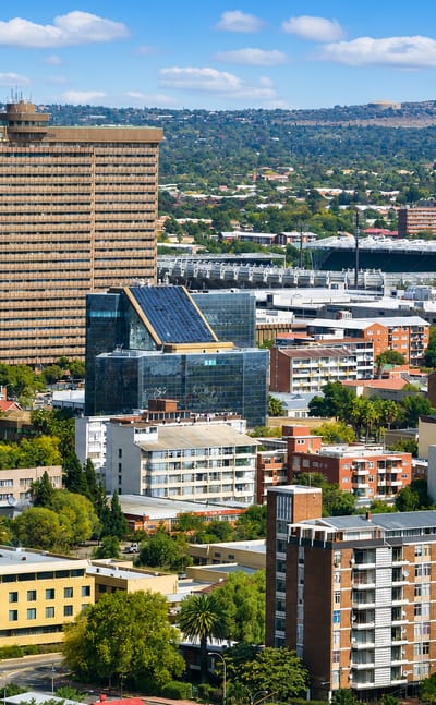 Bloemfontein cityscape with a tall office tower, the Free State rugby stadium and mid-rise buildings