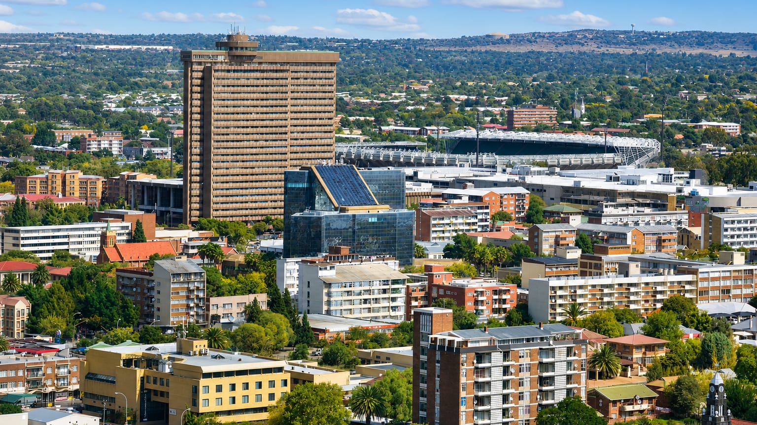Bloemfontein cityscape with a tall office tower, the Free State rugby stadium and mid-rise buildings