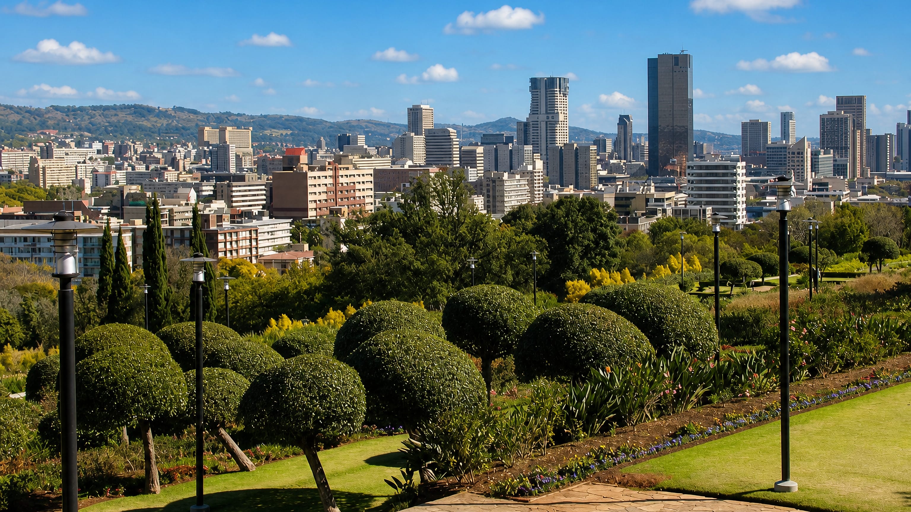 Pretoria's CBD skyline seen from the terraced gardens of Arcadia, with clipped trees and lamp posts
