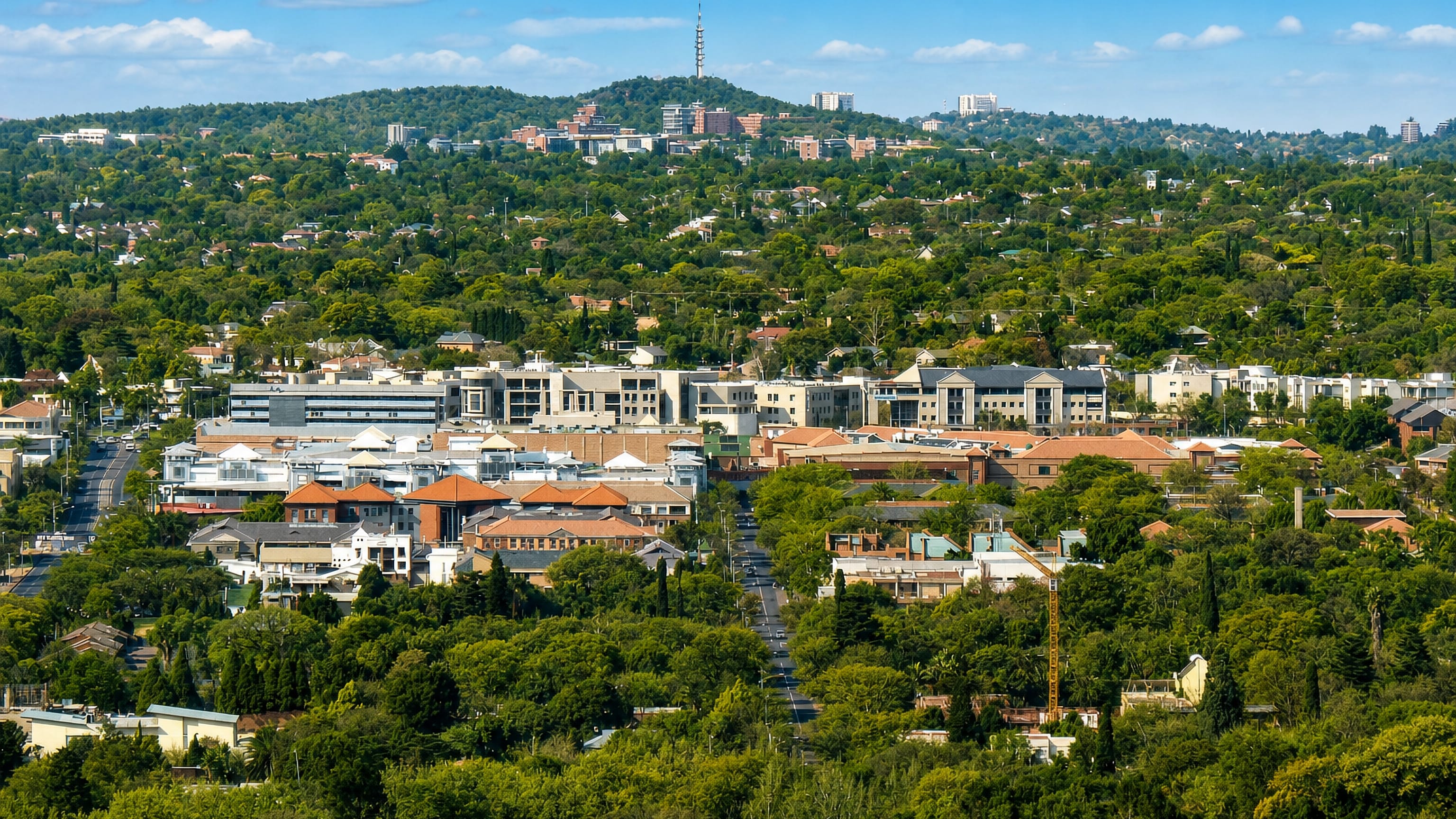 Leafy Brooklyn in Pretoria, offices and shops among trees below the ridge and its telecoms tower