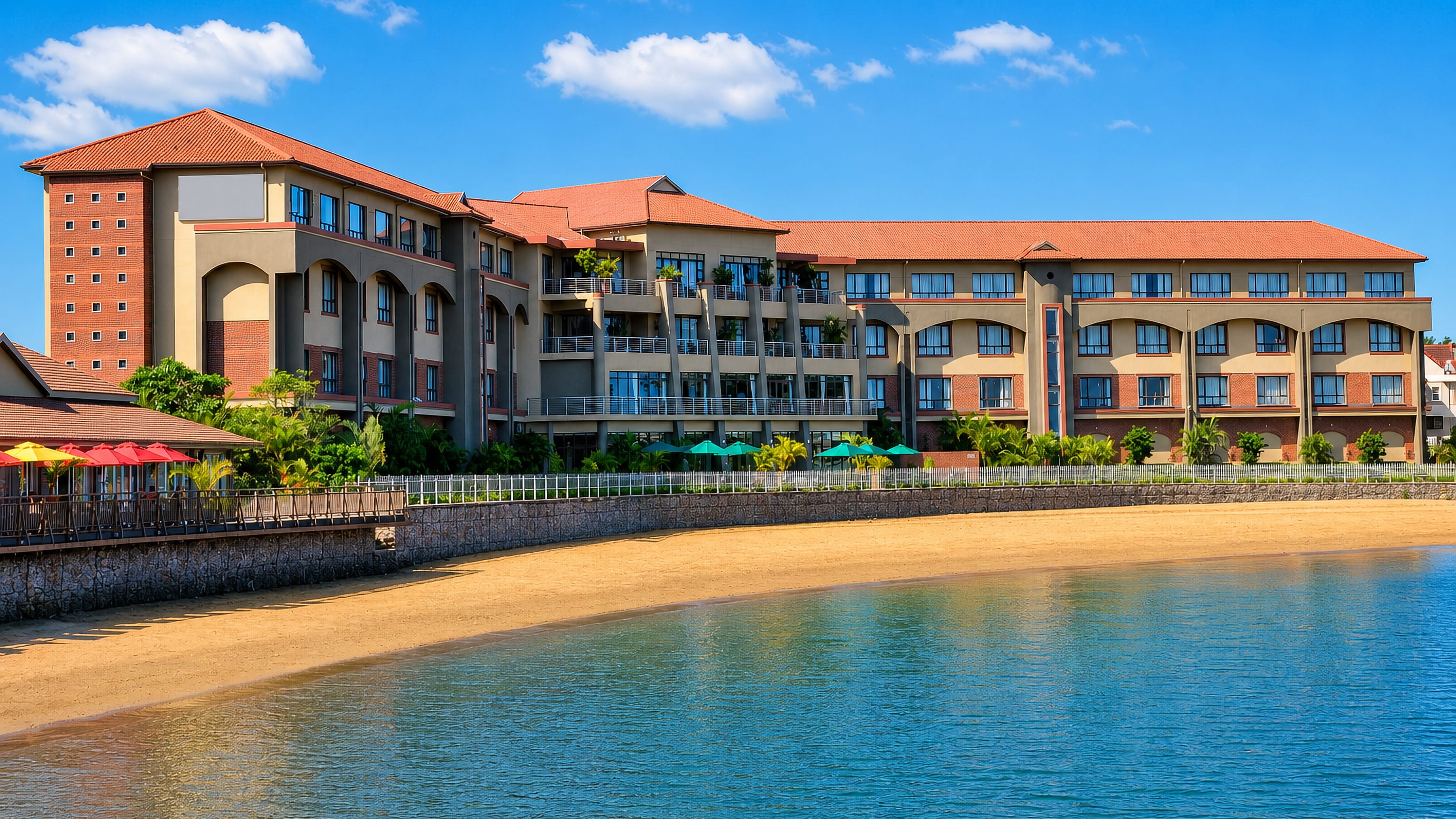 Beachfront resort hotel with red-tiled roofs above a sandy cove in Richards Bay, KwaZulu-Natal.