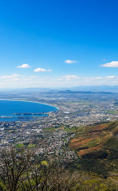 View from Table Mountain over Cape Town's city bowl and Table Bay harbour with a mountain flank on the right