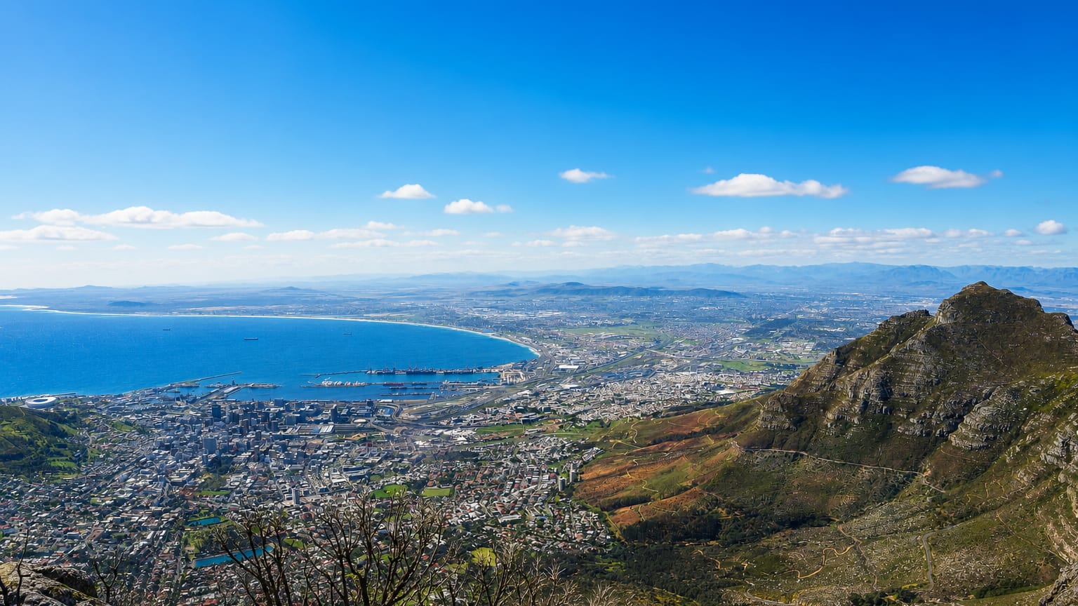 View from Table Mountain over Cape Town's city bowl and Table Bay harbour with a mountain flank on the right